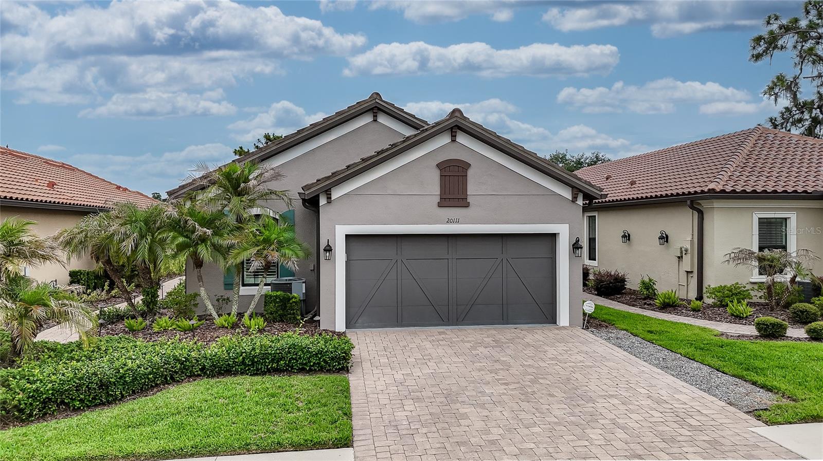 Many listings claim to "show like a model," but this one truly does. METICULOUSLY MAINTAINED with obvious pride of ownership, every detail of this stunning home has been THOUGHTFULLY UPGRADED and beautifully curated. In fact, many buyers will assume the home is professionally staged—it isn't. This is simply how the current owners, with impeccable taste and attention to detail, have chosen to live. Adding to the home's appeal is the EXTENDED BRICK-PAVER LANAI featuring an OUTDOOR KITCHEN, multiple entertaining areas, and a breathtaking UNOBSTRUCTED POND VIEW that creates the perfect backdrop for relaxing Florida living. Located within the GATED ESPLANADE community in New Tampa, this exceptional home offers outstanding curb appeal with a brick-paver driveway and entryway, attractive TILE ROOF, and MAINTENANCE-FREE living with LAWN CARE and EXTERIOR PAINTING included in the HOA. Inside, the popular GREAT ROOM FLOOR PLAN provides an open, inviting layout with 3 BEDROOMS plus a versatile FLEX ROOM behind French doors. Currently used as an office, this flexible space could easily serve as a craft room, fitness area, media room, reading retreat, or additional sitting room. The KITCHEN is both beautiful and functional, featuring a GAS STOVE, BREAKFAST BAR with ample seating, PULL-OUT CABINET SHELVING, PANTRY WITH CUSTOM WOOD SHELVING, ABUNDANT COUNTER SPACE, and an adjoining dining area perfect for everyday meals or entertaining guests. Throughout the home you'll find PLANTATION SHUTTERS on every window, elegant TRAY CEILINGS in the great room, primary suite, and flex room, 5¼-INCH BASEBOARDS, CROWN MOLDING, LAMINATE FLOORING, and custom wood shelving in every closet. The spacious primary suite is a true retreat, complete with a tray ceiling, TRANQUIL POND VIEWS, and a LUXURIOUS ENSUITE BATH with DUAL SINKS and a SHOWER featuring a RAIN-HEAD FIXTURE. The CUSTOM WALK-IN CLOSET is thoughtfully divided into two separate sides, providing organized personal space and storage for each homeowner. Even the LAUNDRY ROOM has been UPGRADED with a utility SINK, folding area, and custom wood shelving. Beyond the home itself, residents enjoy access to an IMPRESSIVE AMENITY CENTER featuring a clubhouse, resort-style pool, dog park, playground  pickleball and tennis courts—all with NO CDD fees. Conveniently located with QUICK ACCESS TO MAJOR HIGHWAYS, MEDICAL FACILITIES, Downtown Tampa, TAMPA INTERNATIONAL AIRPORT, countless DINING OPTIONS, and PREMIER SHOPPING at Wiregrass Mall and Tampa Premium Outlets. HOMES WITH THIS LEVEL OF CARE, UPGRADES, STYLE AND LOCATION RARELY BECOME AVAILABLE. Schedule your private showing today—and BUY IT BEFORE SOMEONE ELSE DOES!