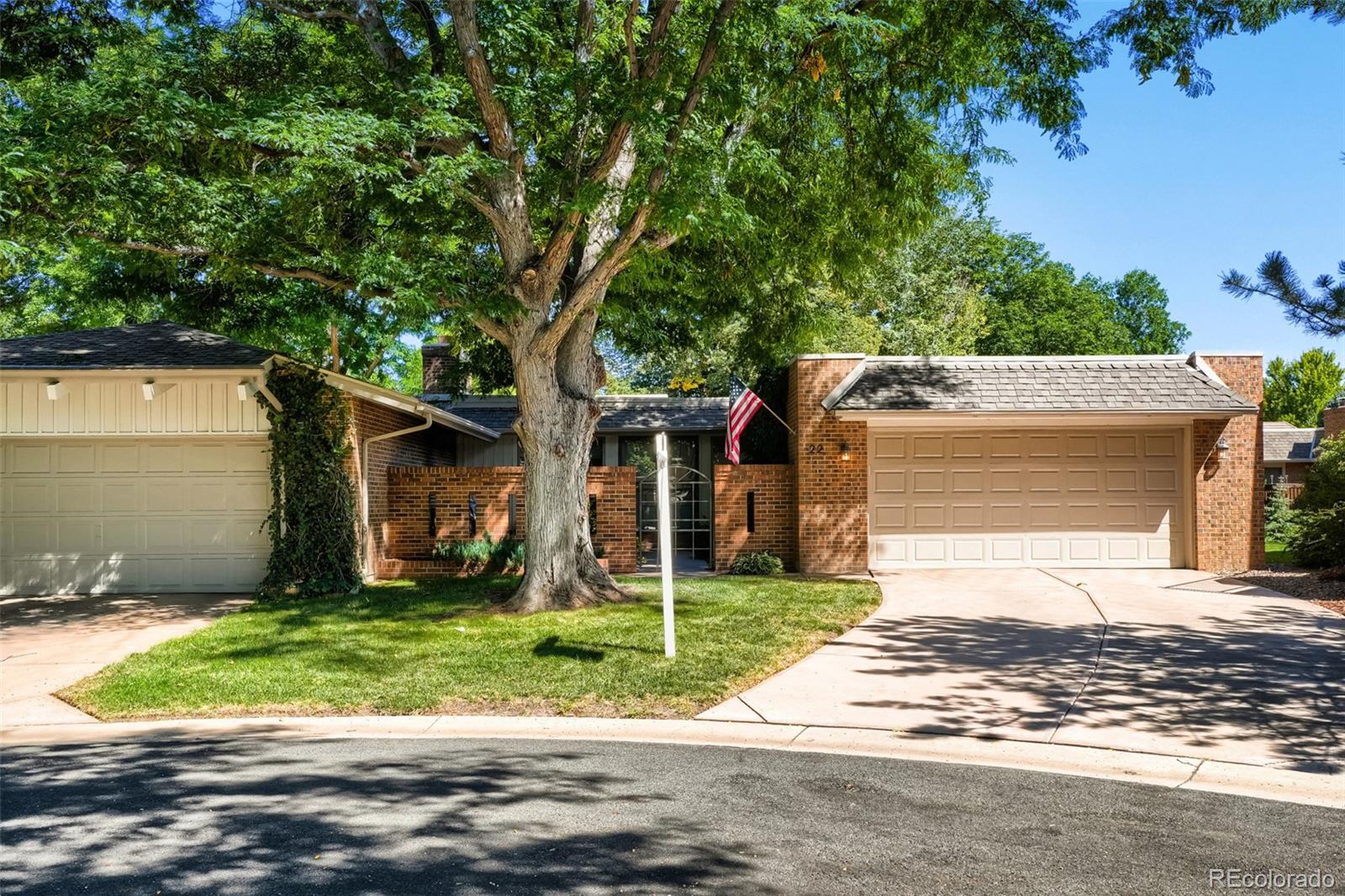 Welcome to one of the larger townhomes in coveted Columbine Villas, a Columbine Valley subdivision, just steps from award winning Columbine Country Club! This spacious, move-in-ready end unit sits on an approx. 5,489 square-foot lot and offers approximately 2,581 square feet of living space, four bedrooms—including one currently used as an office and one non-conforming in the basement. With two generously sized family rooms, including one upstairs and another in the bright garden-level basement, the home offers flexible spaces for relaxing, entertaining, working, or hosting guests.Natural light welcomes you when you enter through the front double door entry and into the foyer, where a skylight in the formal dining room helps to brighten the area. The large upstairs family room opens through sliding glass doors to an oversized covered back patio overlooking abundant open space, creating a peaceful setting for outdoor enjoyment. In the kitchen and adjacent eating area, large newer windows overlook the spacious front patio.  The upstairs laundry room makes that job easy and convenient.The roomy primary suite overlooks the back patio and features a partially remodeled bathroom with a new double-sink vanity, updated lighting, abundant closet space, and a walk-in shower. A second bedroom also enjoys back-patio views. An oversized attached two-car garage adds convenience and possible room for a private golf cart, while the home location offers either walking or private golf cart access to the golf course and country club.  The HOA covers all exterior maintenance, excluding the roof, as well as snow removal up to the front door. With its end-unit setting, flexible bedroom and office options, multiple living spaces, abundant natural light, open-space views, patios, and country club location, this home offers comfortable, low-maintenance living in a sought-after community.