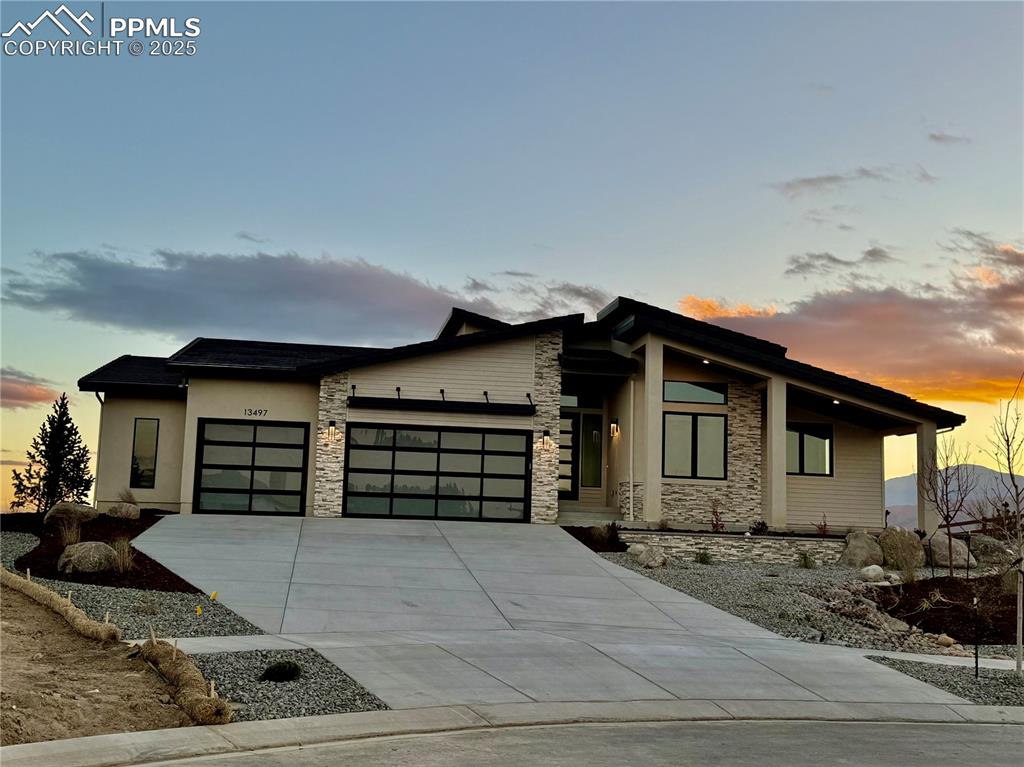 This stunning new Goetzmann Custom Home offers over 5,000 square feet of thoughtfully designed living space on one of the most coveted lots in town—where sweeping views of the Flying Horse Golf Course and majestic Pikes Peak create a truly unforgettable backdrop.The heart of the home is a chef’s dream kitchen, complete with a Wolf gas cooktop and microwave, Sub-Zero refrigerator, Cove dishwasher, and elegant quartzite countertops. A separate prep kitchen provides additional convenience with its own Cove dishwasher and under-counter refrigerator—perfect for entertaining.The main level features a spacious great room with an upgraded linear fireplace and a quartzite surround, opening onto an extended Trex deck that’s partially covered for year-round enjoyment. The study offers a quiet, dedicated space for work or relaxation, and a stunning powder bath adds a touch of luxury for guests. The expansive primary suite includes direct access to the deck and a beautifully appointed 5-piece bathroom with a freestanding soaking tub.Need to get downstairs? Enjoy the convenience of the elevator to enjoy the walkout basement with 9’ ceilings offers a generous rec room with a gas fireplace, an impressive wet bar, and access to a covered patio. Two bedrooms share a Jack & Jill bathroom, while an additional junior suite and a second powder bath complete the lower level.Additional highlights include an elevator for multi-level convenience, an extended 3-car garage, and the high-end finishes and craftsmanship you expect from Goetzmann Custom Homes. Taxes are based upon land only.  All room sizes and specifications should be verified by Purchaser.Landscaping to get installed in the next few weeks.