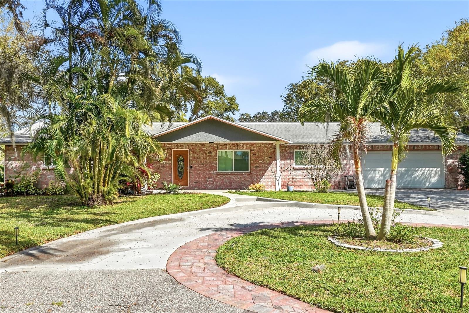 Privately tucked along a quiet road in one of Palm Harbor’s most convenient locations, this beautifully updated 5-bedroom, 3-bath residence offers a rare blend of refined comfort, thoughtful improvements, and everyday accessibility. Just about a mile away and approximately a 4-minute drive to Palm Harbor University High School, the home is also moments from Publix at Crystal Beach Plaza, Wall Springs Park, Innisbrook, and a variety of nearby shopping, dining, and daily essentials.A substantial renovation completed in Spring 2022 elevated the home with a total kitchen remodel including new appliances, beautifully remodeled bathrooms, wood flooring in all five bedrooms and the utility room, fresh interior paint, hurricane-grade windows throughout, and a new back door. Additional enhancements include California Closet organizers in all closets, LED lighting in the living room, kitchen, dining room, and hallway, surround sound in the living room, a water softener and water filtration system, and a replaced and relocated water heater moved from the utility room to the garage. The utility room was also upgraded with added cabinetry and countertop space for enhanced functionality.Continuing the home’s thoughtful care and improvement, the garage floor was painted and coated in Fall 2022, the back patio was re-caged and gutters with downspouts were added in Spring 2023, and the underground septic tank was cleaned and serviced in Spring 2024.With meaningful updates already completed and a location that offers both privacy and convenience, this is a wonderful opportunity to enjoy comfortable, elevated living in the heart of Palm Harbor.