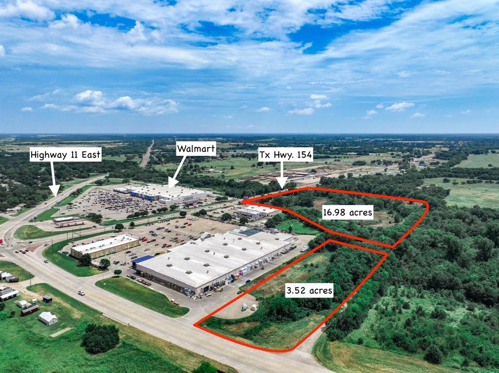 Next to Tractor Supply and Lowes and across from Walmart, sits this 20.5 acres with road frontage on 3 sides including Highway 154 (aka Broadway Street) on the east side! Property also has frontage on Highway 11 (aka Wildcat Way) from the north and Holiday Drive from the west. For utilities, there is an 18-inch sewer line on the property, plus access to a 2-inch water line and 8-inch water line that is close by. Per Texas Department of Transportation, the Daily Traffic count on Highway 154 is 8,625 and 9,268 on Highway 11. Acreage is inside the city limits and zoned Heavy Commercial. A Billboard is also included with property. Total income from property is $1,950 per month. Discover the investment potential this acreage has to offer--next to Lowes and Tractor Supply, near Walmart, a shopping strip mall, and major commercial businesses and restaurant chains!