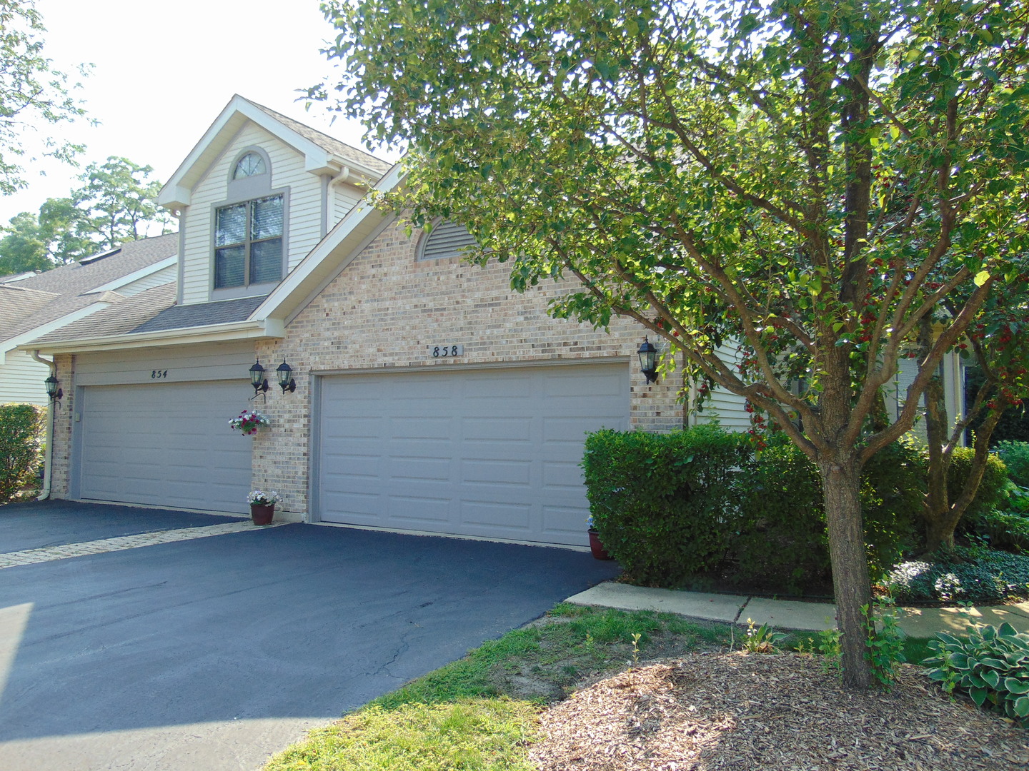 Welcome to this stunning and rarely available end-unit townhome, perfectly situated in a highly desirable community. Thoughtfully designed for comfort and style, this home features a hard-to-find first-floor primary suite complete with a walk-in closet and luxurious marble bath with a relaxing jacuzzi tub. The bright and spacious kitchen eat in kitchen is a true standout, boasting marble countertops, a center island, built-in hutch and cathedral ceilings with skylights. The inviting living room offers soaring ceilings, additional skylights, a cozy gas fireplace, and direct access to a private patio-ideal for relaxing or entertaining. Upstairs, you'll find a second bedroom, full bath, and an open loft area that overlooks the main level-perfect for a home office, reading nook, or guest lounge.  The beautifully finished lower level adds even more living space with a large recreation room, wet bar, additional bedroom, and full bath-perfect for guests or extended family. Nestled in a serene, wooded setting with a private backyard, this home feels like a peaceful retreat while being just minutes from everything. Add in a friendly neighborhood and convenient location, and you've found a truly exceptional place to call home.