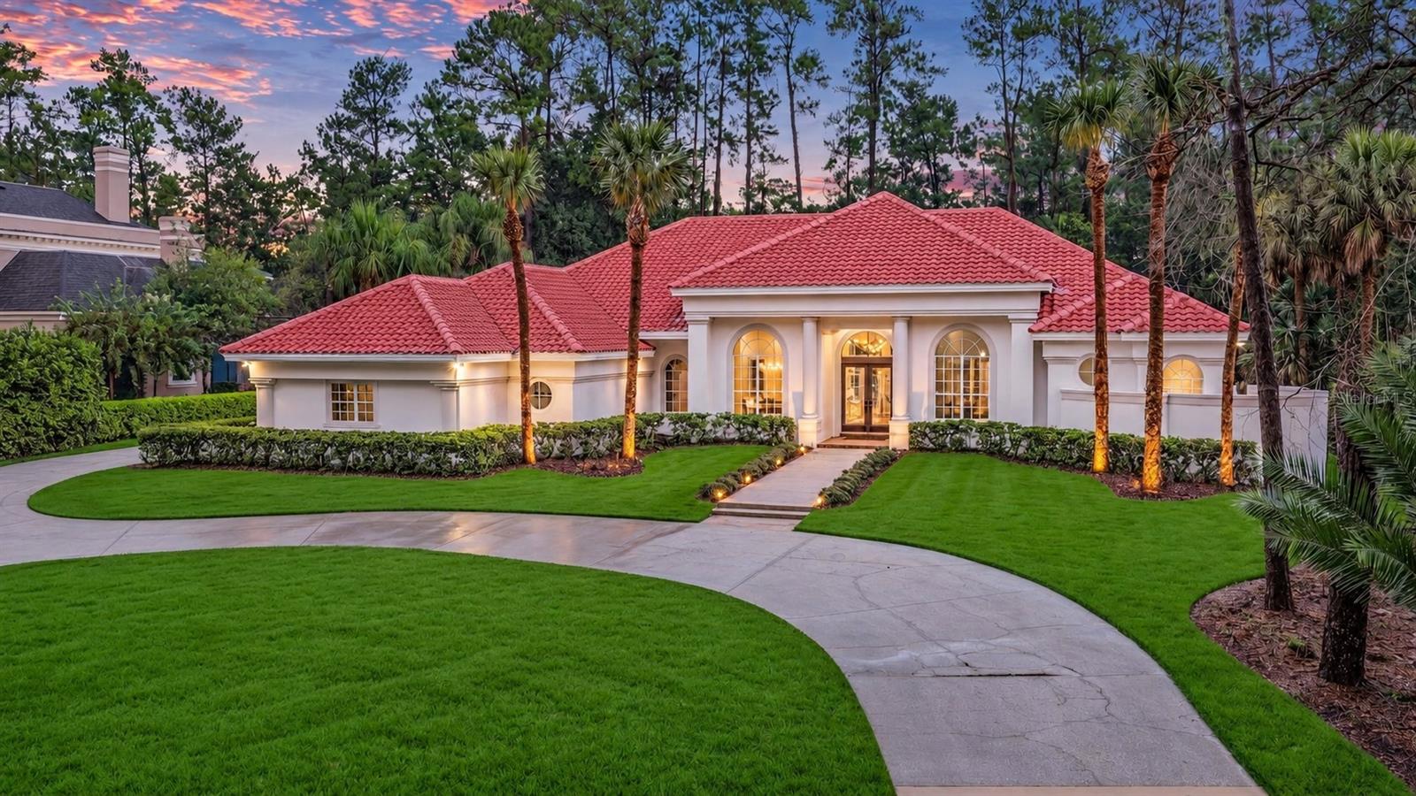 Turnkey 1-level Dave Brewer custom nestled on 1-acre homesite in 24-hour guard-gated Alaqua.  Discover three generously sized bedrooms PLUS an oversized private office with a closet, easily functioning as a fourth bedroom. Designed with both form and function in mind, the thoughtfully planned floor plan features expansive formal living and dining rooms along with a spacious family room—creating an ideal setting for both everyday living and effortless entertaining. From the tile roof replaced in December 2020 to the extensive interior and exterior renovations completed in 2026, this beautifully updated residence offers the opportunity to simply move in and enjoy the Alaqua lifestyle without the time, expense, and inconvenience of undertaking a major renovation. Arrive along the impressive oversized circular driveway and immediately experience a sense of tranquility, enhanced by picturesque golf course views across the front of the property. Double glass entry doors welcome you into a light-filled interior showcasing soaring ceilings, abundant natural light, beautiful wood flooring throughout much of the home, and an exceptionally functional layout. At the heart of the residence, the chef-inspired kitchen features new appliances and opens seamlessly to the generously proportioned family room, highlighted by an elegant fireplace and expansive views of the pool and oversized covered lanai. The primary suite is truly a private retreat, complete with a spa-inspired ensuite bath and dual walk-in closets. Outdoor living is equally impressive, with an expansive lanai, sparkling pool, and summer kitchen creating the perfect backdrop for year-round entertaining. Additional highlights include an oversized, extra-deep three-car garage and numerous thoughtful updates throughout. Completing the lifestyle, championship-level golf is just moments away at Alaqua Country Club, placing one of the area's premier golf experiences practically at your doorstep. All this and much more with incredible proximity to major highways, great schools, and world-class shopping, dining, and attractions.  This property may be under audio/visual surveillance.