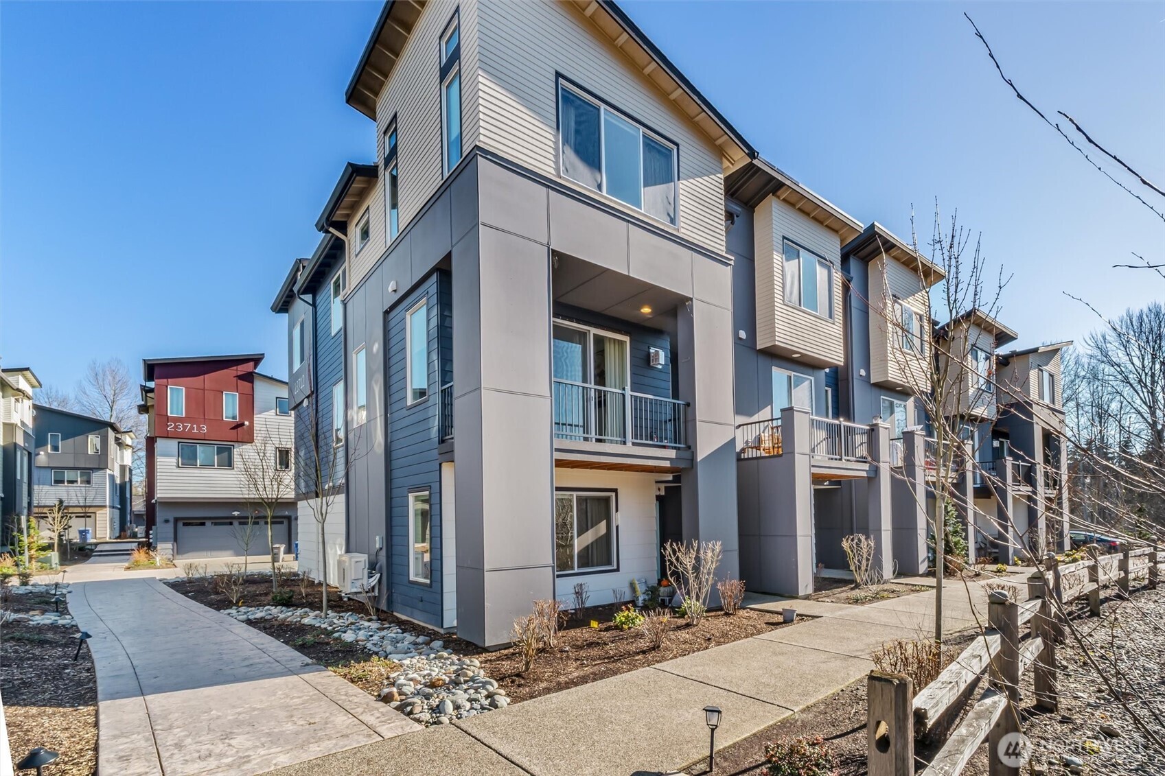 Don’t miss this stunning 4-bedroom, 3.25-bath townhome in sought-after Urbane Village II, right in the heart of Bothell. Spacious 2,249 sq ft, this light-filled East West facing home offers a highly functional layout with thoughtful upgrades throughout. The main level features an open-concept living and dining area, perfect for entertaining, with engineered hardwood floors, a cozy gas fireplace, and abundant natural light. The chef’s kitchen boasts beautiful sage green cabinetry, upgraded quartz counters, stainless steel appliances, an oversized island with ample storage. Step out to the covered deck ideal for year-round entertaining with privacy overseeing GREENBELT. A guest bedroom on the lower level includes an attached ¾ bath, making it perfect for visitors or a private home office. Upstairs, you’ll find two additional spacious bedrooms, a laundry area, and a luxurious primary suite featuring vaulted ceilings, a spa-inspired bath & a custom walk-in closet by California Closets. Highlights include custom desk/work area Ring doorbell, Wi-Fi–enabled garage door opener & front door lock, plus an energy-efficient Mini split A/C system. In ceiling surround sound wiring. EV car charger. POE for wifi on each level. 2-car garage & extra storage. Mins from Bothell Landing, UW Bothell, parks, dining, & 405—perfect blend of modern living and unbeatable location. No rental cap. Top rated NSD schools Shelton View Elementary. Low Hoa. Fee simple townhome you own the land. Welcome Home.