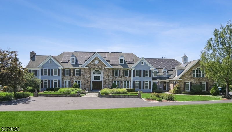 Welcome to this magnificent custom Colonial estate, gracefully set on over 10 acres of pristine land. Offering 7 bedrooms and 7.3 baths, this grand residence showcases exceptional craftsmanship and timeless elegance throughout. A stately double staircase greets you in the grand foyer, setting the tone for the home's refined interiors. The chef's eat-in kitchen features fine cabinetry, high-end appliances, a butler's pantry, and thoughtfully designed spaces ideal for entertaining. The family room is adorned with soaring ceilings and expansive windows that flood the space with natural light. Rich mahogany finishes, immaculate red oak flooring, and detailed marble accents elevate the home's interior. Enjoy the warmth and ambiance of seven fireplaces throughout, including in the sophisticated private home offices. The expansive primary suite boasts serene views, a generous sitting room, two fireplaces and a spa-like bath with a steam shower. Five guest bedrooms offers their own private ensuite bath. The walk-out lower level features a custom temperature-controlled wine room, massive rec. room with a custom wet bar, a home theater and an exercise room while the exterior offers a covered deck with fireplace, multiple patios and a heated saltwater pool.This sale includes 9.08 acres of farm assessed land that's adjacent to the main property. This extraordinary estate must be experienced in person to be truly appreciated.