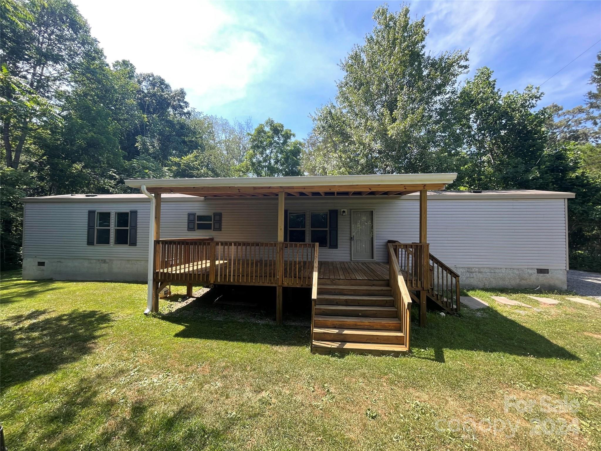 This charming home is perfect for a first time home buyer, someone looking to downsize, or as an investment property. Well maintained home on .26 flat acres with large 10X20 workshop and 10X16 metal shed. This spaciuos home boasts 2 bedrooms, 2 full bathrooms, a bonus room, with an open floor plan with a large kitchen, and a 12X24 large covered front deck. Recently painted and move in ready. Only 20 mintues from downtown Asheville and the Asheville Airport.