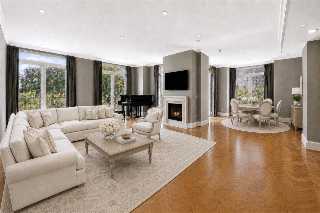 Impeccable quality, design and attention to detail is seen throughout this 4E unit at The Vendome. Originally designed as a two-bedroom residence, the floor plan was opened to create a grand and exceptionally spacious one-bedroom unit with four private balconies. This wonderful 4E unit is ideal for both everyday living and entertaining with a lock-and-leave lifetyle. Step inside to a spacious foyer welcoming  you to the grand living room and dining room with tall ceilings, mantled fireplace with gas logs; solid oak flooring with an intricate herringbone pattern, designer wallpapers and floor-to-ceiling windows viewing the Dallas skyline and surrounding cityscape. The spacious balconies provide year-round enjoyment. The sleek kitchen is outfitted with a 4-burner Thermador professional oven, Bosch dishwasher, built-in microwave and Sub-Zero refrigerator. Custom walk-in pantry features pull out shelving and beverage rack. The hall closet by the Owner’s Suite provides a full-size washer and dryer. The inviting and private Owner’s Suite includes two separate bathrooms, two walk-in closets and a siting area. Residence 4E offers a home full of charm and craftsmanship thoughtfully reimagined for modern living. Two parking spaces and extra storage space convey with this unit. The Vendome resort style amenities include a heated pool with cabanas, outdoor pavilion with gas grills for outdoor cooking, entertainment room with terrace and catering kitchen, owner’s library, fitness center, 3 guest suites, dog park, 24-hour valet and concierge service.