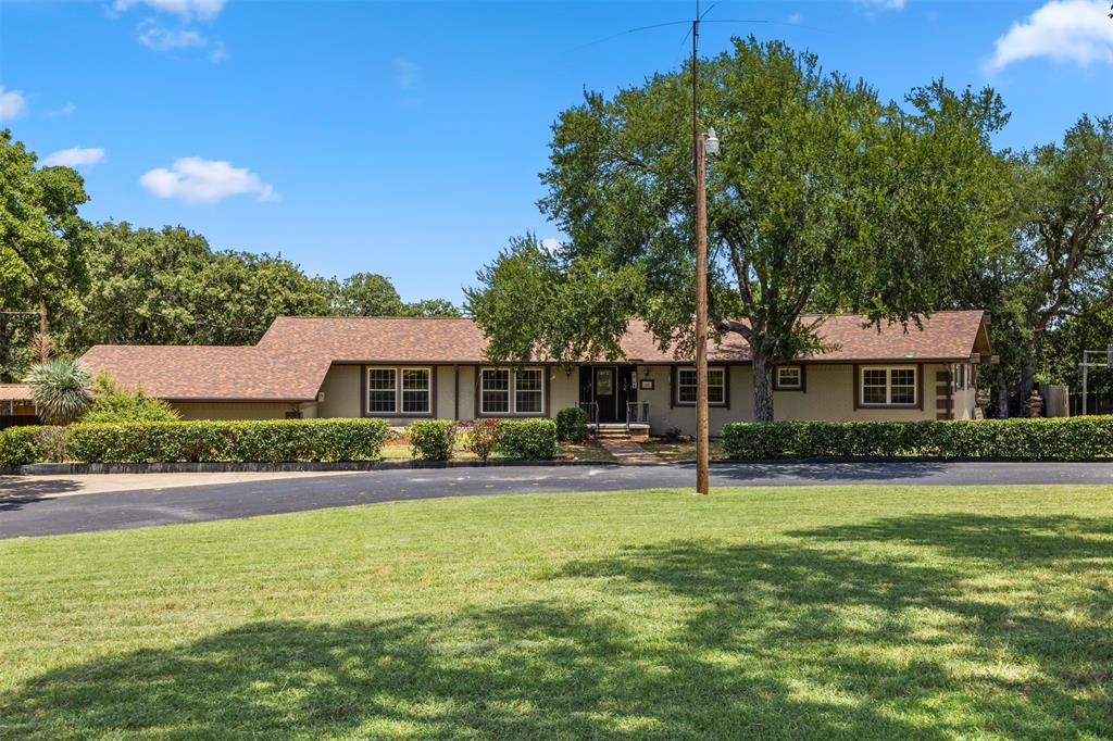 -Welcome to this rare and remarkable ranch-style estate that perfectly blends peaceful country living with the convenience of city access—located less than a mile from Hwy 287! Situated on a gated lot, this sprawling 5-bedroom, 3-bath home has a basement. This home is an ideal layout for families, remote workers, and hobbyists alike. Step inside to a grand entryway that opens to a formal dining area and a sunken living room featuring a show-stopping stone fireplace. The office is adjacent to the living room.  It has built-in desk, bookshelves, a siting area and an exit to the side yard that is perfect for that home office. From the living room there is access to the backyard that has a large covered patio and deck. The backyard is a true sanctuary—lush, shaded by mature trees, and full of possibility. Whether you're hosting large gatherings or dreaming of your own pool, trampoline, or backyard ball games, there's space to make it happen. An additional paved sports area with basketball goal offers fun for the whole family. Gardeners and home chefs will love the numerous fruit trees and planter boxes, perfect for growing your own organic vegetables and herbs. An expansive circular drive with covered parking for six vehicles and RV space. Inside, updates bring a fresh feel while maintaining the charm of this unique property. The open-concept kitchen boasts granite countertops, a breakfast bar, abundant cabinetry and pantry storage. . The east wing of the home includes two spacious secondary bedrooms, a utility room, and a lovely primary suite with an oversized walk-in closet, garden tub, and separate walk-in shower. On the opposite side of the home, you’ll find another large bedroom, full bath, easy basement access, and a fifth bedroom near the carport—perfect for guests or multigenerational living. Onside your gate, enjoy direct access to a neighboring walking park, pond, and play areas for children—adding even more to the family-friendly charm of this estate.