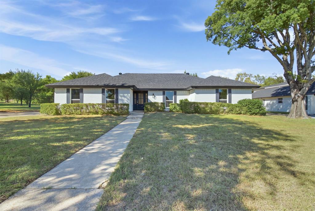 Beautifully updated single-story home on approximately 0.61 acres in the heart of Colleyville! Featuring a new HVAC system, new roof, and new windows, this home pairs modern updates with timeless charm. Mature trees, a spacious front lawn, and a striking white brick exterior create inviting curb appeal.Inside, the bright, open living area features vaulted ceilings with exposed wood beams, a painted brick fireplace, recessed lighting, and warm wood-look flooring throughout the living spaces and bedrooms. The thoughtfully designed kitchen showcases warm wood cabinetry, elegant veined countertops, a center island, stainless steel appliances, and gold-tone fixtures. A walk-in pantry with generous shelving and a built-in work surface provides exceptional storage, while large windows in the adjoining dining area overlook the backyard.The primary suite offers a beautifully updated bathroom with dual sinks, a spacious glass-enclosed shower, gold-tone accents, and a walk-in closet with built-in storage. The secondary bathroom features coordinated finishes, a dual-sink vanity, and a tiled tub surround.Step outside to a patio and expansive backyard with mature shade trees and plenty of space for entertaining, gardening, or creating your own outdoor retreat. Enjoy updated interiors, major improvements, and generous outdoor space in Colleyville!
