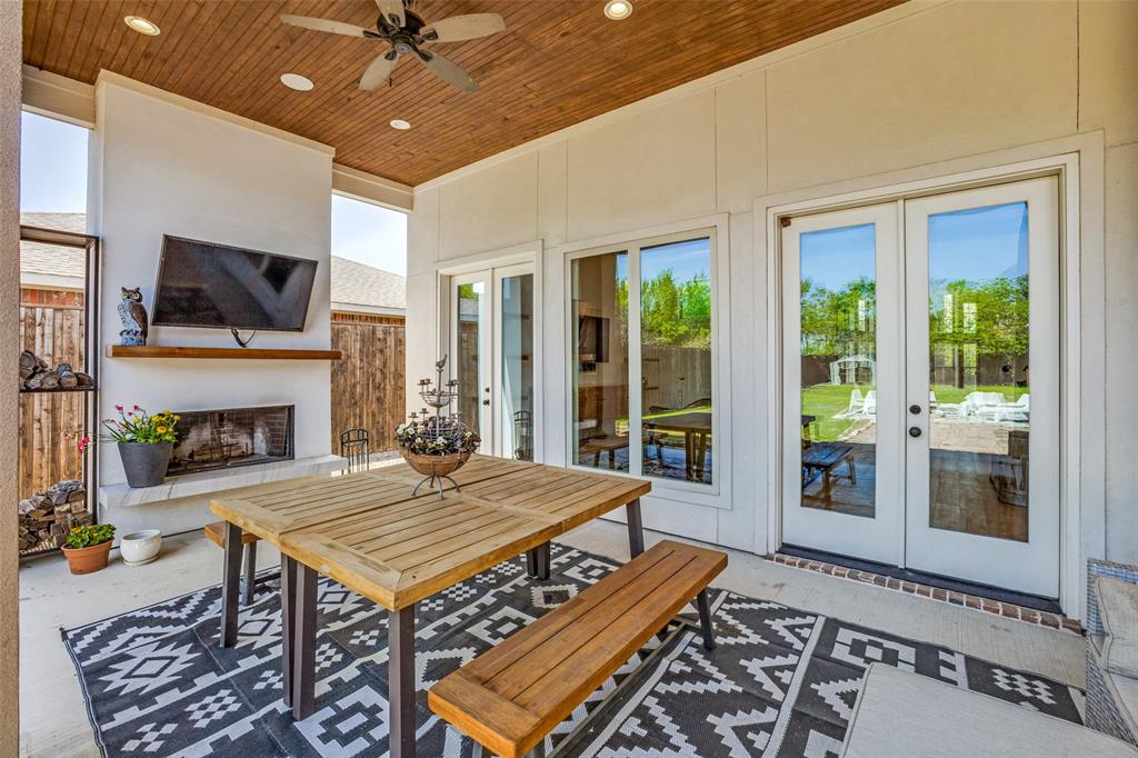 Extend your living and dining area to the outdoors. Lot is 70 x 250.  Thus covered patio all under roof with double french doors and a healthy amount of sunlight leading from the great sized family room.  Large wood burning fireplace with hearth and place for TV. Wood panel vaulted ceiling with recessed lighting and 2 ceiling fans.  Room for large patio tables and benches plus outdoor sofa.  So inviting to just  rest and relax or entertaining large groups of family and friends.  You will never want to leave home again!
