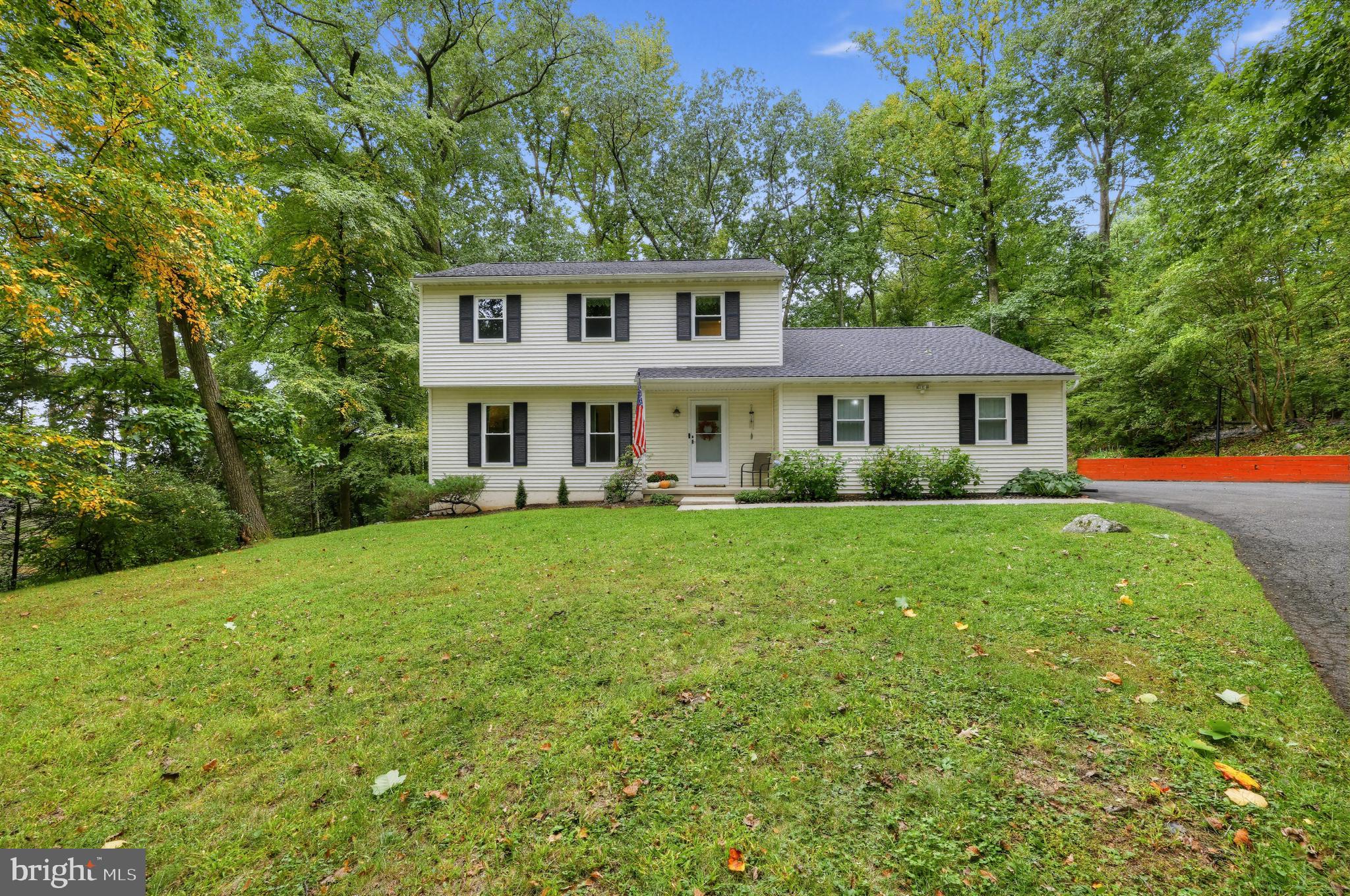 Welcome to 52 Spring Road! Nestled on a private, nearly 1-acre wooded lot in Boyertown, this fully updated 3-bedroom, 1.5-bath single-family home offers exceptional move-in readiness and total confidence from day one! You’ll enjoy peace of mind knowing the heavy lifting has already been done with these upgrades: a new main roof and shed roof (2023), brand-new energy-efficient windows and front door (2024), and a high-efficiency heat pump with central air (2020). Inside, the main level features an inviting layout with low-maintenance laminate flooring throughout the living and dining rooms, both painted in neutral colors.  The updated kitchen shines with sleek Quartz countertops, a classic subway tile backsplash, stainless appliances including a DW, ample cabinet space, and an area to sit and enjoy that morning cup of coffee.   The adjacent dining room, featuring crown molding leads out through a new sliding glass door to an expansive back deck that overlooks the peaceful, wooded yard. Unwind in the cozy den, complete with a new propane fireplace insert and a ceiling fan. Upstairs, you will find three bedrooms—including a primary bedroom outfitted with custom built-in closet shelving—and a full hall bath featuring a new vanity (2024), LVP flooring, and a Bath Fitter tub/shower.  Additionally, the second-floor hall provides attic access. The versatile finished lower level significantly expands your living space, offering a spacious family room with sheet vinyl flooring alongside a separate private home office finished with laminate flooring. Additional basement features include an active radon mitigation system, a whole-house water filter and softener system (2018), storage space, and a washer/dryer hookup. Complete with an attached 2-car garage, storage shed, and a large driveway providing ample parking, this home effortlessly combines serene country living with contemporary updates.  Don't let this home pass you by!