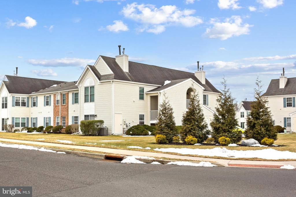 Experience first-floor living at its finest in the highly desired Holiday Village East community. This  2-bedroom, 2-bathroom residence has been reimagined for modern comfort, featuring brand-new, spa-inspired bathrooms and stylish, durable LVP flooring throughout the spacious living and dining areas.The airy, open-concept floor plan offers plenty of natural light and centers around a warm living room fireplace—the perfect focal point for a cozy evening. The layout flows seamlessly through elegant French doors into a bright sunroom, providing a versatile bonus space for your morning coffee or a quiet afternoon of reading. Completely turn-key and move-in ready, this gem offers total peace of mind in a meticulously maintained community. Ideally located just minutes from  shopping, dining, and major commuter routes including I-295 and the NJ Turnpike.