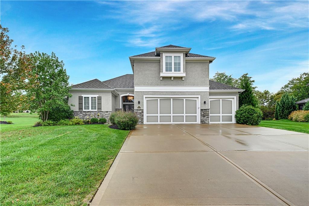 With an exquisite blend of comfort and convenience, this sophisticated 1.5 story home, built by Encore Homes, has an inviting, sun-filled floor plan boasting upscale finishes throughout. Main level features hardwood floors, great room with stacked native stone fireplace, floor-to-ceiling windows, massive built-ins and coffered ceiling. Designer kitchen features black stainless appliances with 5-burner gas range, French door refrigerator, microwave/convection 2nd oven, huge eat-in island plus classic granite counters. Bonus butlery with prep sink, bev. fridge and quartz counter opens to large walk-in pantry. Spacious seating in breakfast room looks out to verdant backyard. Elegant powder room conveniently located in hallway plus rear foyer has mud area/drop zone with built-in bench. Primary suite is spacious with large walk-in closet and luxurious bathroom plus adjoining laundry (recently updated with sink, quartz counters + added storage). Wide, open staircase leads to second floor loft – perfect for family area or home office. Upper level features three ample bedrooms – each with walk-in closets. Both second floor bathrooms are trimmed with crisp, white tile and tall vanities. Outdoors you can delight in the perfection of the massive, private backyard (over half an acre!) and multiple patio areas. Lush landscaping recently added with lovely outdoor lighting. Lower level has high ceilings, stubbed for full bathroom and full egress window, so there’s plenty of room to grow. Can we talk about this perfect garage? Professional epoxy floors, custom cabinetry/workbench/wall slat storage plus EV charger. Tiffany Greens neighborhood amenities include community center, award-winning golf course, scenic landscaping, swimming complex with 25-meter pool + separate children’s pool. Fantastic Platte County schools with Barry Elementary and Platte City Middle feeding to Platte County High.