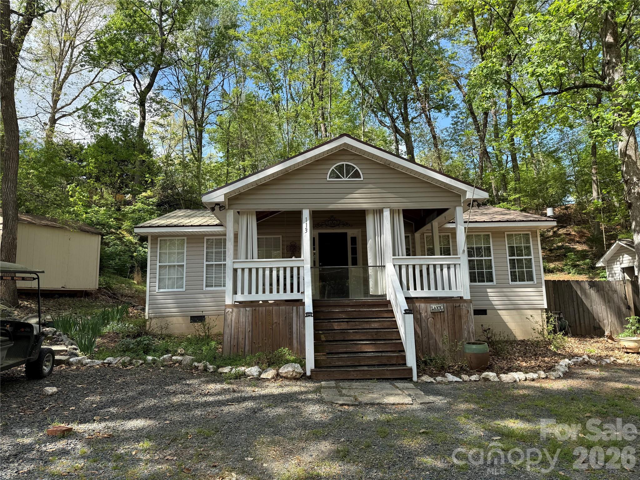 Welcome to 113/115 Indian Harbor Cir. Quiet location within the park. Extra large master bedroom that accommodates a king size bed with plenty of room left to use. Large living room that is open to the dining area and kitchen. Decent size second bedroom. Step in shower and a real potty. Awesome covered front porch. HVAC throughout with supplemental propane heater in living room for cold winter nights. Dishwasher, washer/dryer, stove and microwave all to remain.  Most furnishings included but not master bedroom set. Elec water heater 5 1/2 years old. Metal roof is approx 6 years old. New flooring 7 years ago. No title to camper, bill of sale with be provided. There is some overlap with the last lot on the street on the west side. Last lot carport and fence in back yard to next to last lot are exchanging some space. All buyers must be with a realtor to gain access to the community.