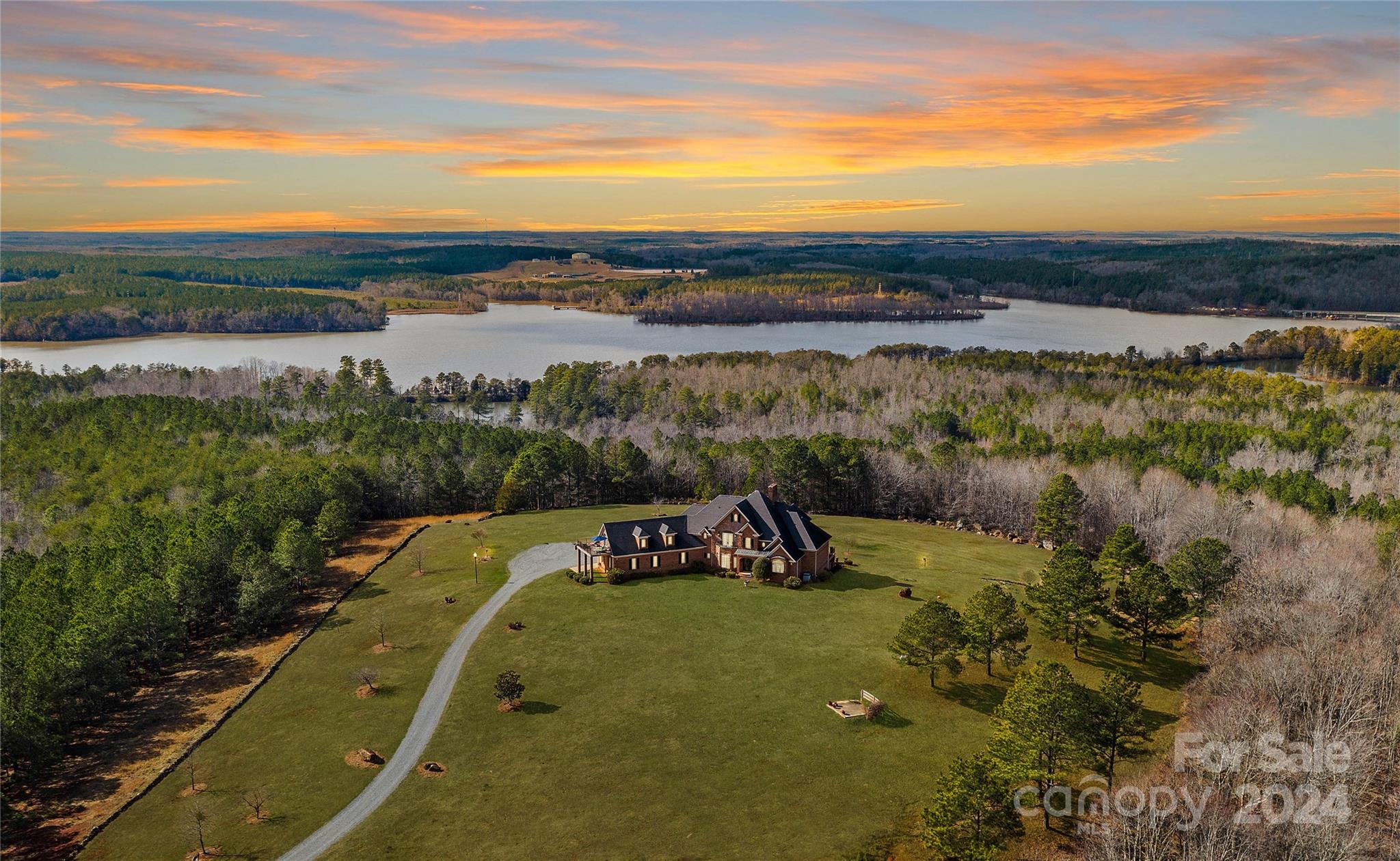 Wow! Exclusive Opportunity to own The Tuckertown Estate with choice of your 50 acres! Buyer now has the opportunity to draw lot lines and enjoy this exquisite private property. With 9000sqft+, this custom built home overlooks the National Forest w/ a breathtaking view of Tuckertown Reservoir. Bring your UTVs & your toys and explore the endless trails and features amongst your land. Home features 10-12ft ceilings throughout, expansive windows w/ nightly sunset views & upgrades galore. Notable features include Chef's kitchen w/ designer SS appliances & large island; heated/cooled epoxy coated 2-car garage, mud room, sitting room & 2story great room. Primary suite has thermostatic gas fireplace, 2 generous custom walk-in closets, jetted tub and shower! Upstairs - 2BR/2BA, HUGE bonus room with privacy balcony and additional sitting area/loft. DREAM Basement hosts additional bar, kitchen, billiard area, 2BR/2BA, workout room & more! Perfect for unique hunting lodge or equestrian estate!!