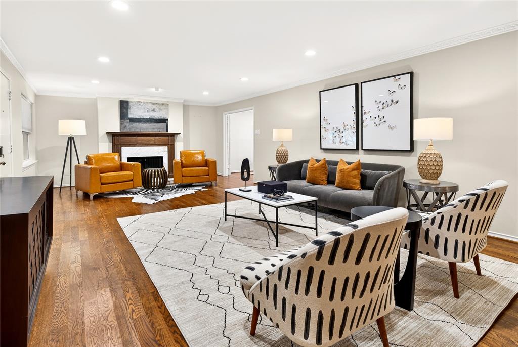 Tucked behind the iconic Pink Wall, this beautifully renovated 2-bedroom, 2-bath residence offers turnkey living in one of Dallas’s most sought-after enclaves. Hardwood floors and a cozy fireplace anchor the main living area, creating a warm, inviting space for both everyday living and entertaining. A private study off the living room adds flexibility and is a rare feature for this unit.Newly installed windows fill the home with natural light and provide peaceful treetop and pool views. The updated kitchen features custom cabinetry, quartz countertops, a stylish backsplash, recessed lighting, and premium appliances, thoughtfully designed for both form and function.The spacious primary suite includes an updated bath with a framed glass shower, quartz countertops, and a stacked washer and dryer for added convenience. The secondary bedroom offers its own ensuite bath with upgraded finishes.The HOA covers all utilities, common area maintenance, and access to the community pool. Two assigned parking spaces convey. This is a true move-in-ready opportunity where the renovations are complete and the lifestyle is effortless.