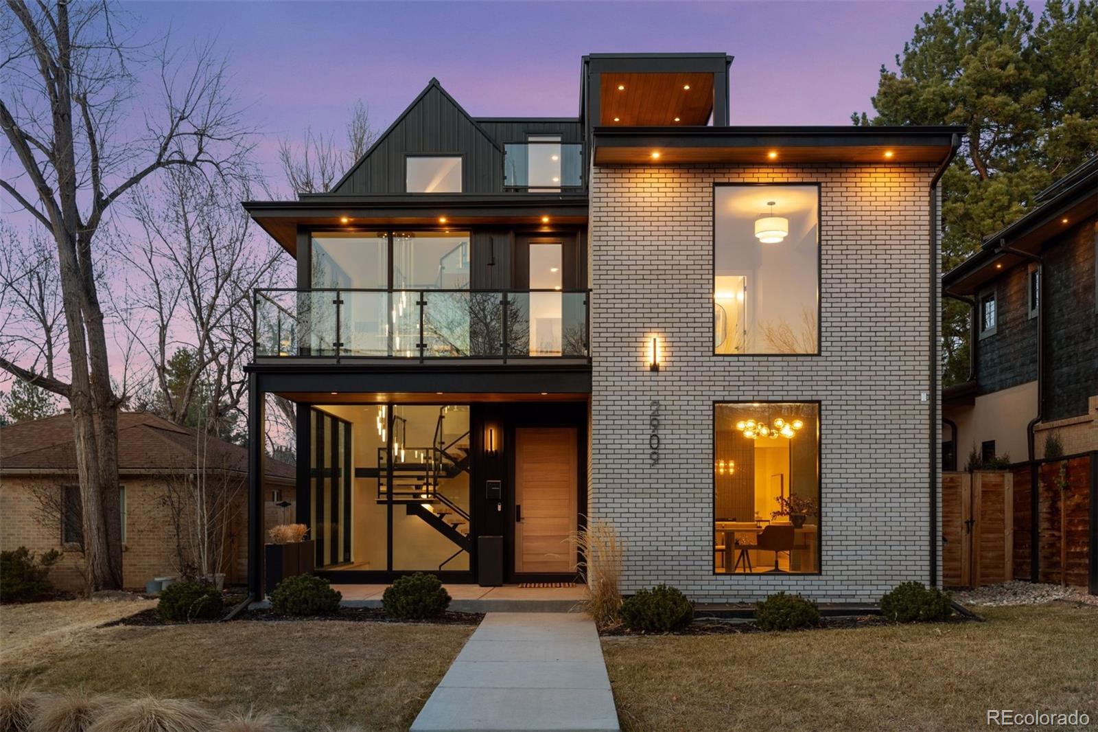 Exceptional modern home intentionally designed to maximize every inch of a coveted lot. The luxury kitchen features an upgraded appliance package, double ovens, and a hidden pantry discreetly housing the coffee maker and microwave—maintaining a clean, modern aesthetic. Designer light fixtures throughout the home and bathrooms pair with floor-to-ceiling windows to flood the space with natural light, enhanced by western and southern exposure for stunning sunsets.A pass-through fireplace seamlessly connects the living and dining rooms, creating warmth without sacrificing openness. A dedicated home office overlooks Bonnybrae, while 11-foot ceilings in the basement provide ideal scale for a golf simulator, media room, or elevated recreation space. The extended basement bar with island is built for hosting, with an adjacent room perfectly suited for a custom wine cellar.An entire glass wall opens to the backyard, creating approximately 15 feet of seamless indoor-outdoor living. The expansive entertainment deck features its own bar, bathroom, and multiple balconies—an exceptional setup for gatherings of any size. CAT-6 cabling throughout supports modern connectivity, while a whole-home steam humidifier ensures year-round comfort. A rare third parking space on the opposite side of the garage adds flexibility for additional vehicles, gear, or toys.This home offers a rare blend of luxury, thoughtful design, and efficient use of space in a premier setting.