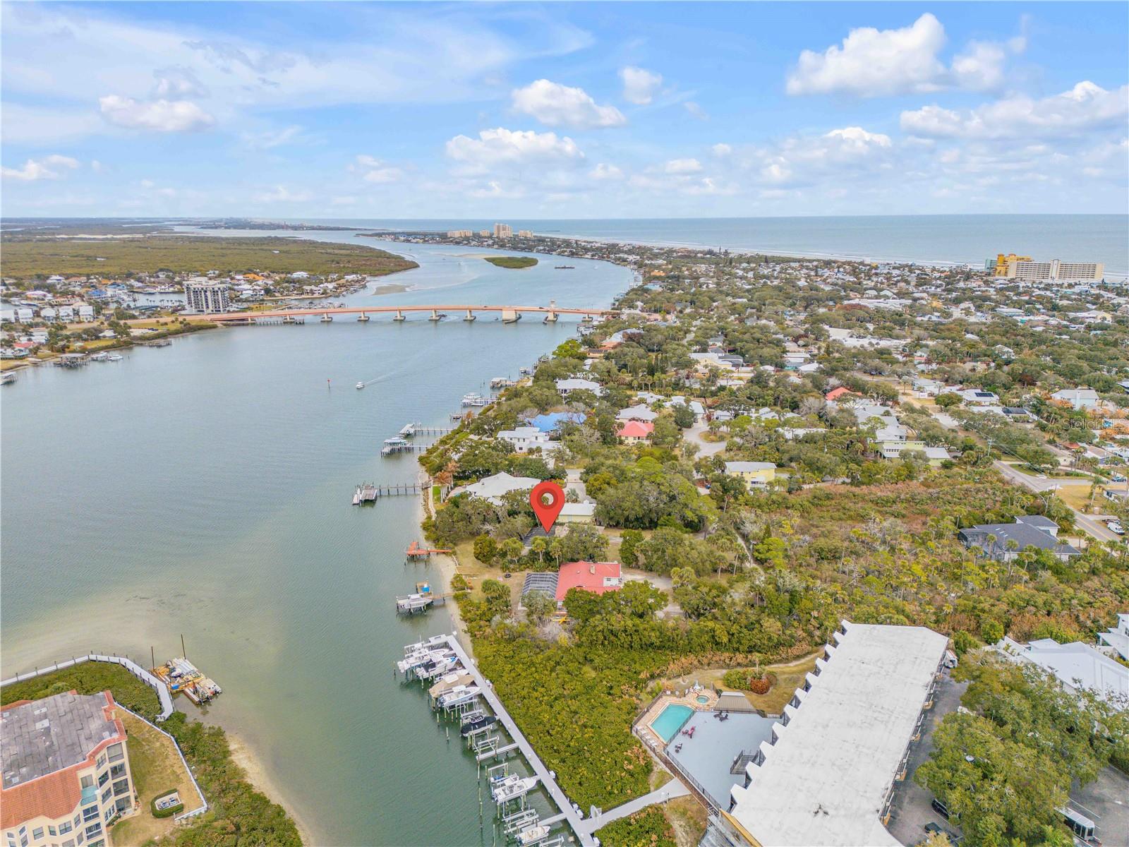 Direct Intracoastal Waterway "Indian River" deep water frontage 3 Bd, 2 Ba, 1 Car Garage home in a prime New Smyrna Beach location. There is a fireplace in the living room with tile and terrazzo flooring throughout. This kitchen has a breakfast bar and the home has ceiling fans. This oversized riverfront parcel totals approximately 0.65 acres with roughly 90 feet of frontage and deep lot depth offering flexibility for future development. A 20x18' dock is included. Current zoning is single-family residential.  Walk to historic Flager Ave and Canal Street dining, shopping and entertainment.  Minutes to New Smyrna Beach.  This property is ideal as a primary residence, or vacation get away.