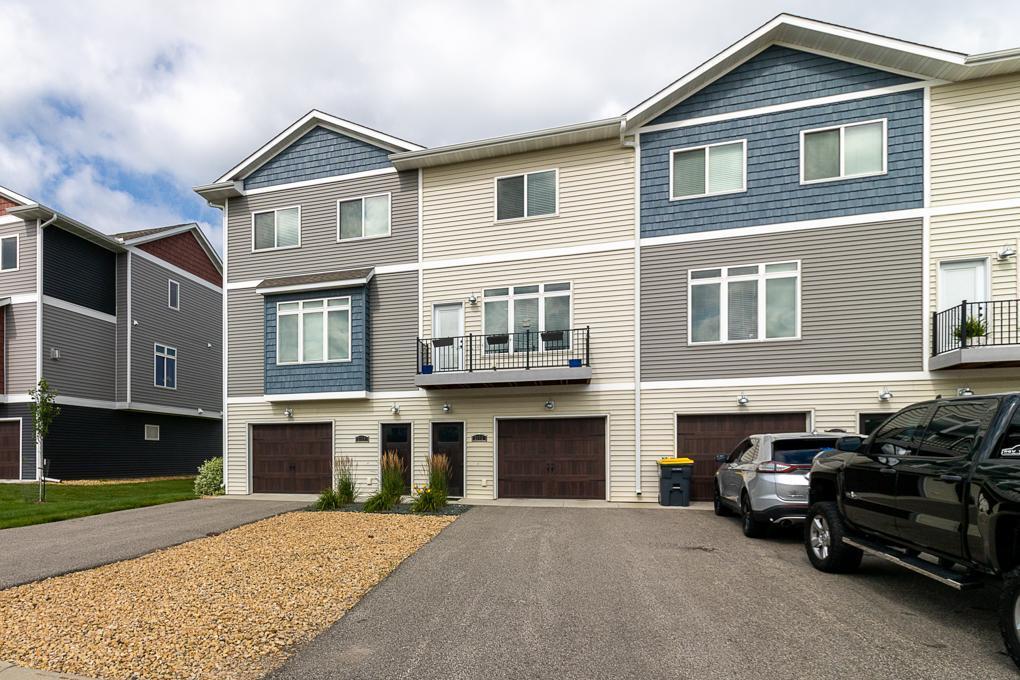 Welcome to this beautifully maintained 3-bedroom, 3-bathroom townhome offering simple living in a bright and airy space. The first level features one bedroom, a full bathroom, a kitchen with a center island, and a spacious living room filled with natural light—perfect for relaxing or entertaining. A private balcony extends your living space outdoors. On the upper level, you'll find two separate bedrooms, each with an ensuite bath—ideal for privacy and convenience. This level also includes a conveniently located laundry area for added ease. A 2-car tandem garage provides generous parking and storage, with additional off-street parking conveniently located across the road. This property also holds a current rental license and is grandfathered to allow up to five unrelated occupants—an excellent opportunity for flexible living arrangements or future investment potential. Situated in a great location within a well-kept community and close to local amenities, this home blends function, comfort, and modern style.