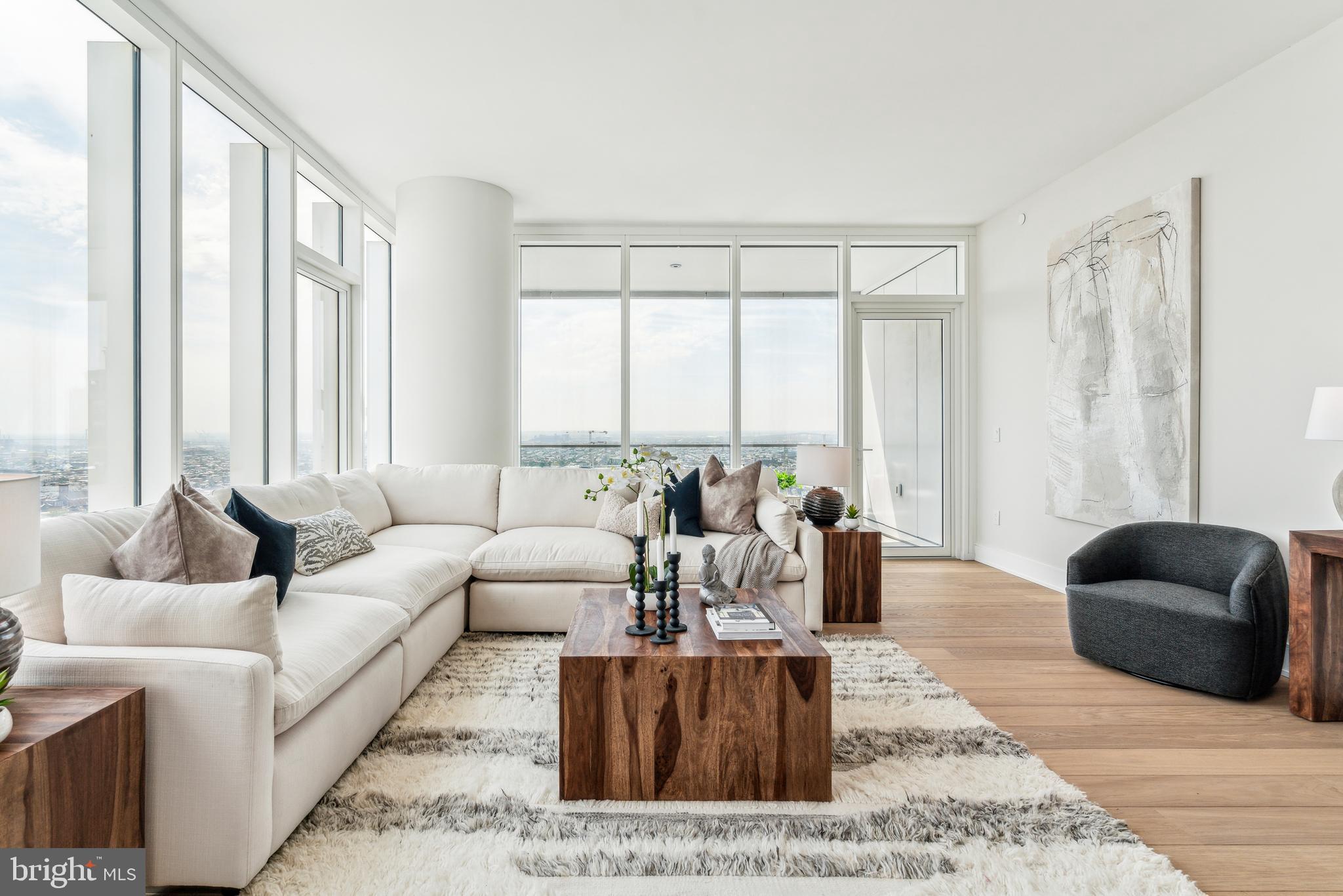 Arthaus, a commanding new residential high-rise in Philadelphia’s vibrant Performing Arts District, presents Residence 2202—a stunning 2-bedroom, 2.5-bath, 1,817-square-foot single-level home with sweeping midtown views, offered at $1,635,000.This maintenance-free, move-in-ready residence features sophisticated interior design, resort-style amenities, and white-glove services. A tax abatement is available. Whether you’re a busy professional, discerning retiree, or global traveler, Residence 2202 is a must-see.Arthaus impresses from the moment you enter. A tall, solid wood entry door with elegant hardware opens into a spacious, light-filled foyer with a generous coat closet, a convenient powder room, and a dedicated laundry room. The expansive Great Room blends kitchen, living, and dining areas into a seamless entertaining space, highlighted by soaring ceilings, floor-to-ceiling windows, wide-plank Havwoods hardwood flooring, and a weather-protected walk-out balcony. Bathed in natural light, the home feels bright, airy, and significantly larger than its square footage suggests.The chef’s kitchen is designed for hosting, anchored by a large center island with seating for four. The Poggenpohl cabinetry in polar white pairs beautifully with Golden Gate quartz countertops and matching backsplash for a crisp, modern aesthetic. The premium stainless appliance suite includes Wolf, Sub-Zero, Bosch, and Asko, with fully integrated cabinet fronts for a seamless, bespoke finish.The bedroom wing is located on the east side of the residence. The guest bedroom offers tranquil midtown views and a walk-in closet, making it ideal for guests or a home office. The adjacent full bath features porcelain Calacatta tile flooring, super white quartz countertops, and polar white matte Poggenpohl cabinetry.The spacious Owner’s Suite is wrapped in 10-foot floor-to-ceiling windows and includes two step-in closets. The spa-inspired primary bath is appointed with a Badeloft soaking tub, double vanity with Robern mirrors, super white quartz marble countertops, Contempo white marble floors and shower tile, and a private Kohler water closet, delivering a best-in-class luxury experience.Arthaus is a modern architectural masterpiece developed by Carl Dranoff, designed by Kohn Pedersen Fox, and built by Intech Construction. The building prioritizes wellness and lifestyle, from the Monet-inspired mosaic lobby to the private resort spanning the 6th and 7th floors, featuring a pool, fitness center, spa, salon, pet park, outdoor terraces, lawns, gardens, and more. White-glove services include a 24-hour doorman, concierge, chauffeured town car, and valet parking.This residence includes one parking license. With the tax abatement, annual real estate taxes are approximately $3,443.