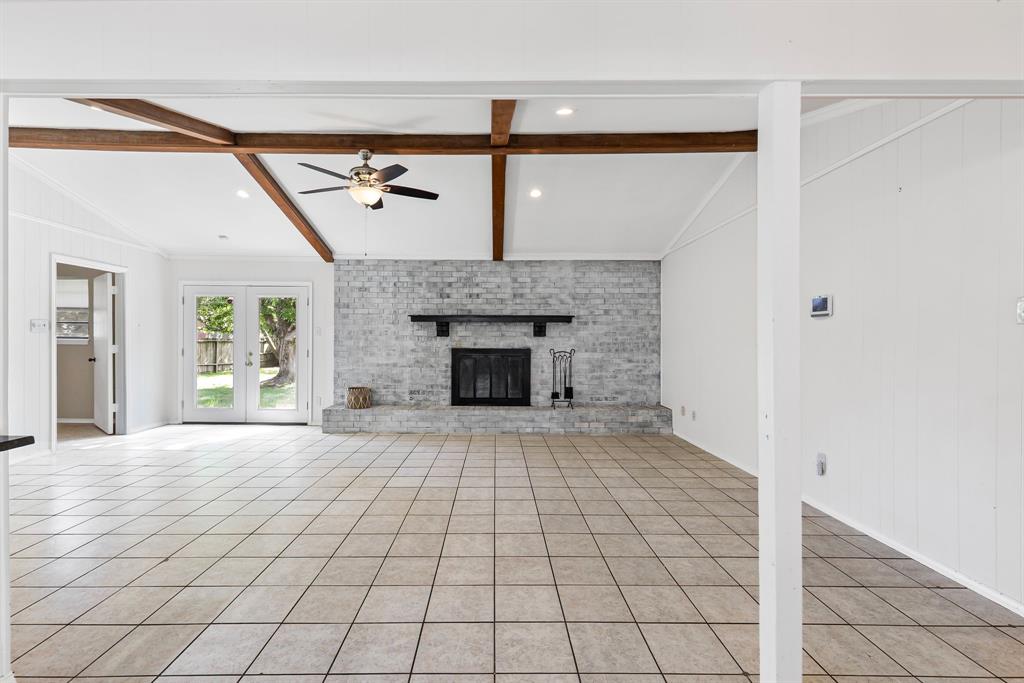 A tree-shaded lot gives tremendous curb appeal to this 3 bedroom, 2 bathroom with 2-car garage! After stepping inside the foyer, you'll notice the white-brick wood-burning fireplace in the vaulted-ceiling living room with wood beams and an eat-in dining area to the left. The kitchen includes a large u-shaped area with granite countertops, extra seating with a long breakfast bar, sleek-black subway tile backsplash, white cabinets, and stainless steel appliances. Double patio windows with a door in the living room, gives you access the shady backyard with privacy-wood fencing. Ceramic tile flooring is found in the living, dining, utility-mud room, and bathrooms. The primary bedroom comes with an ensuite bathroom that has a vanity seating area. Off the garage, you'll find a mud room and an enclosed utility area with shelving. Neutral paint colors provide a blank slate for your decorating ideas. Ceiling fans are also located in living room, dining area, and bedrooms. Park your cars in the attached 2-car garage or use the space as a game room, hobby space, or flex room. In an established neighborhood, this cute home with treed lot is also within walking distance to Lake Coleman, Coleman Park, walking trails, fishing, and picnic areas. A great home and location in town!