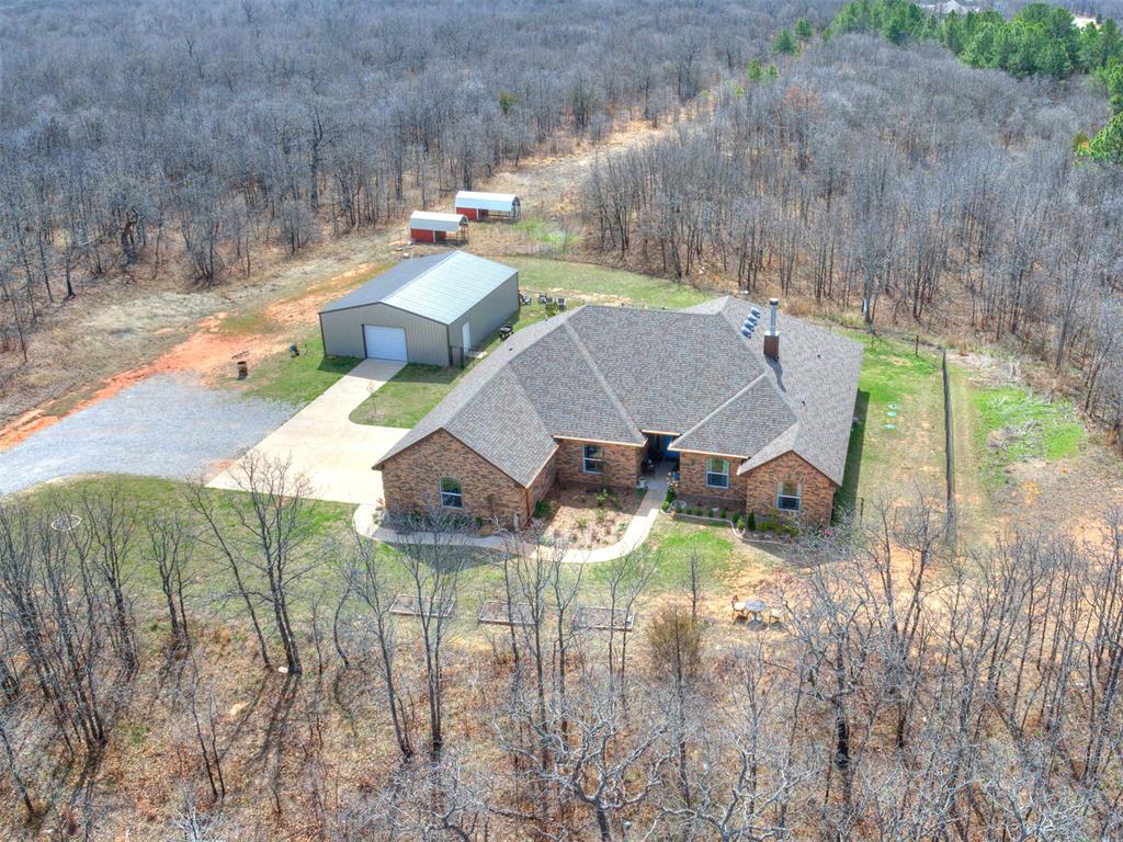 Take a look at this stunning, better-than-new home set on just under 8 acres (MOL), offering the perfect mix of modern comfort and peaceful country living. With 5 bedrooms, 3 bathrooms, and a 3-car garage, this spacious home features an open-concept layout designed for both everyday living and entertaining. The thoughtfully designed split floorplan provides privacy for everyone, with two bedrooms in one wing, two additional bedrooms in another, and the primary suite tucked away on its own. Unique custom touches throughout—like accent wallpaper on ceilings and upgraded light fixtures—add character and style you won’t find in a typical build. In addition to the bedrooms, there’s a versatile bonus/flex room that can easily serve as a home office, media room, homeschool space, or hobby area to fit your needs. The kitchen and living spaces shine with custom cabinetry, granite countertops, and stainless steel appliances, blending functionality with a polished look. Quality craftsmanship and attention to detail are evident throughout the home. Step outside and you’ll find a 30x40 shop ready for projects, storage, or workspace needs, complete with a concrete slab, walk-through door, overhead door, and moisture barrier insulation. A portion of the property is enclosed with black chain-link fencing, making it a great setup for pets. As an added bonus, the road is scheduled to be paved soon, making this already desirable, No HOA location even more appealing.