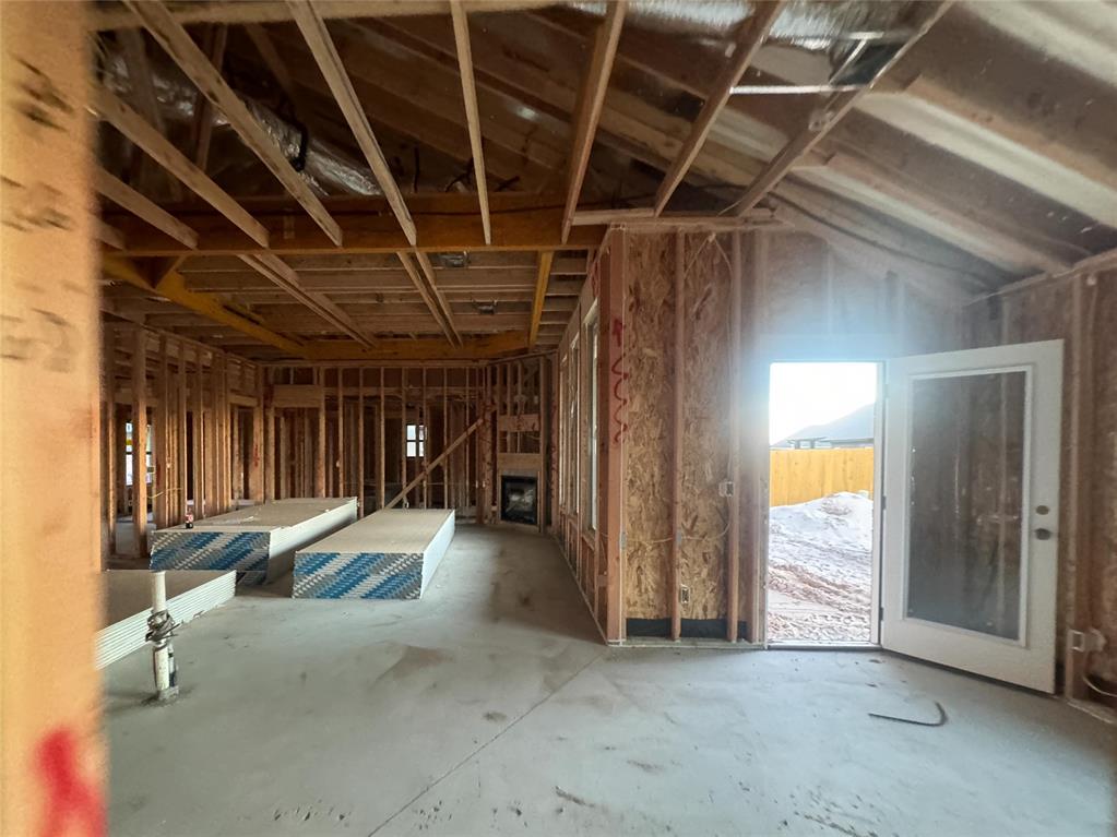 This Hazel A2 floor plan has a total of 2,095 Sqft for living space, including 1,900 Sqft of indoor living and 220 Sqft of outdoor living that features a wood-burning fireplace, a gas line, and a TV hookup! This immaculate home offers 4 bedrooms, 2 full bathrooms, covered patios, a utility room, and a 3-car garage with an in-ground storm shelter installed. The great room presents a beautiful coffered ceiling with a ceiling fan, a gorgeous corner gas fireplace with our stacked stone detail, large 7’ windows, rocker switches throughout, and elegant wood-look tile. The high-end kitchen has stainless-steel appliances, including a 5-burner cooktop, decorative tile backsplash, custom-built cabinets to the ceiling with under cabinet lighting and cabinet hardware installed throughout, a large corner pantry, 3 CM countertops, more wood look tile, stunning pendant lighting, and an oversized center island that holds a spacious sink, a dishwasher, and a trash can pullout. The primary suite spotlights a sloped ceiling detail with a ceiling fan, windows, and our cozy carpet finish. The spa-like prime bath has a free-standing tub, a dual sink vanity with framed mirrors, 3 CM countertops, a European walk-in shower, a private water closet, and a huge walk-in closet with horizontal and vertical storage opportunities. Secondary bedrooms feature high ceilings with ceiling fans, sizeable closets, windows, and carpeted flooring. Other amenities for this energy efficient home include a tankless water heater, a fresh air ventilation system, R-44 and R-15 insulation, and so much MORE!