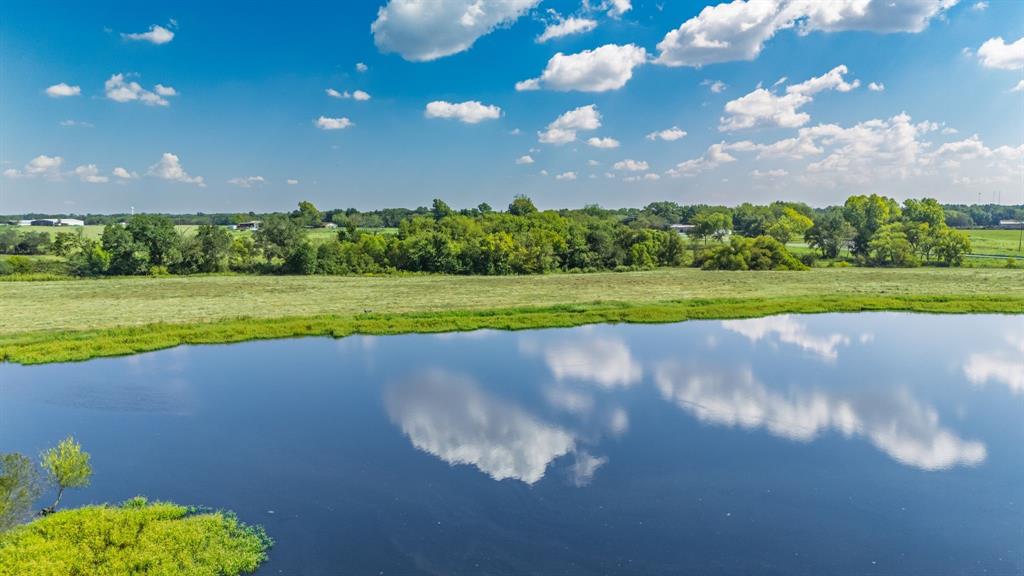 Rare opportunity to own a private lake estate property just south of Sulphur Springs in highly desirable Northeast Texas. This exceptional 31.69-acre tract features a scenic 4+ acre spring-fed lake stocked with bass, catfish, and bream, productive hay meadow, and multiple elevated custom homesite locations overlooking the water. A gravel drive winds from the entrance along the shoreline to several private rear build sites—ideal for creating a signature waterfront residence or family retreat. With approximately 3,000 feet of highway frontage, the property offers outstanding accessibility, privacy flexibility for homesite placement, and long-term investment appeal. Utilities are already in place with water and electricity on-site, and the land currently benefits from an agricultural tax exemption, making it ideal for horses, cattle, hay production, or a hobby ranch lifestyle. Plenty of room for a barn, shop, guest house, or RV setup. Located within sought-after Miller Grove Independent School District and conveniently positioned: 10 minutes to Sulphur Springs, 15 minutes to legendary bass fishing at Lake Fork Reservoir, Approximately 1.5 hours to the Dallas–Fort Worth metroplex, Easy access to major regional medical care in Tyler. Surrounded primarily by long-established neighboring properties rather than dense development, this tract offers the clean country setting many DFW relocation buyers are actively seeking—with space for recreation, livestock, and lakeside living. Properties combining spring-fed private water, stocked fishing, utilities in place, significant highway frontage, ag exemption status, and multiple premier homesites rarely become available in this area. Ideal for a legacy homesite, weekend retreat, or investment-quality land hold.
