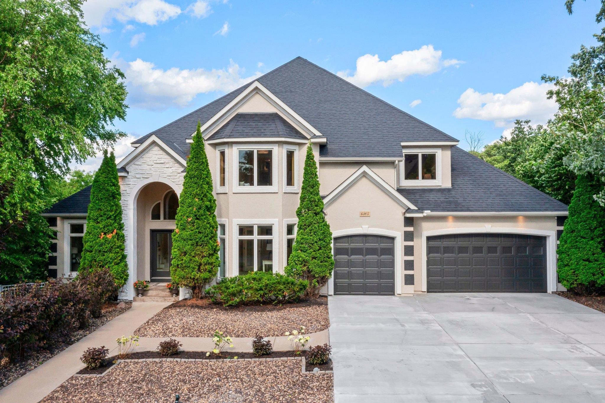 This beautifully remodeled 6-bedroom, 6-bathroom home offers a rare turnkey opportunity in one of Edina’s most desirable neighborhoods—Arrowhead Point. Tucked away on a quiet cul-de-sac, the home has been fully updated inside and out with modern finishes and thoughtful design, providing both privacy and convenience. Enjoy easy access to scenic parks, walking and biking trails, top-rated dining, premier shopping, major highways, and all the Twin Cities have to offer from this central, sought-after location. Step into the grand foyer featuring soaring 18-foot ceilings, refinished hardwood floors, a striking staircase, and two spacious walk-in closets. The fully remodeled kitchen boasts custom cabinetry, a panel-front Sub-Zero refrigerator, JennAir double wall oven, Bosch dishwasher, quartz countertops, a large center island with seating, and a 6x6 walk-in pantry. Adjacent, the sunlit informal dining area offers direct access to the wraparound deck—perfect for seamless indoor-outdoor entertaining. The formal dining room impresses with a statement chandelier, new plush carpeting, and a well-appointed wet bar with built-in wine rack. The main-level family room is warm and inviting with a gas fireplace, custom shelving, new carpeting, and large windows that fill the space with natural light. The formal living room, located at the front of the home, flows effortlessly into a bright sunroom with deck access and oversized windows. A dedicated main-level office offers a bay window, French doors, new carpeting, recessed lighting, and built-in cabinetry—ideal for working from home. A stylish powder room, large mudroom, and fully equipped laundry room with quartz counters, built-ins, and new Whirlpool appliances complete the main level. The oversized 5-car tandem garage with freshly painted floors offers ample space for vehicles, storage, and hobbies. Upstairs, the spacious primary suite features new carpeting, dual walk-in closets, and a double-sided fireplace. The luxurious en suite includes a jetted tub, walk-in shower, private water closet, and dual-sink vanity. Bedrooms two and three feature walk-in closets, bay windows with built-in benches, and share a Jack-and-Jill bath with private vanity areas. Bedroom four overlooks the backyard and includes its own full bath with a separate vanity space. The expansive walk-out lower level includes a family and rec room with 11-foot ceilings, a gas fireplace, and abundant natural light—perfect for entertaining. Bedrooms five and six each offer walk-in closets and new carpeting. Two full bathrooms, including one with a double vanity and linen cabinet, serve the lower level along with a large unfinished storage space for added flexibility.
Outdoors, enjoy a private, resort-like backyard oasis. The in-ground heated pool with brand new pool liner, expansive deck, updated patio with firepit, and tranquil waterfall provide the ultimate setting for summer enjoyment. Nearby Arrowhead Lake, Creek Valley School Park, Bredesen Park, and easy highway access offer endless opportunities for recreation and lifestyle.