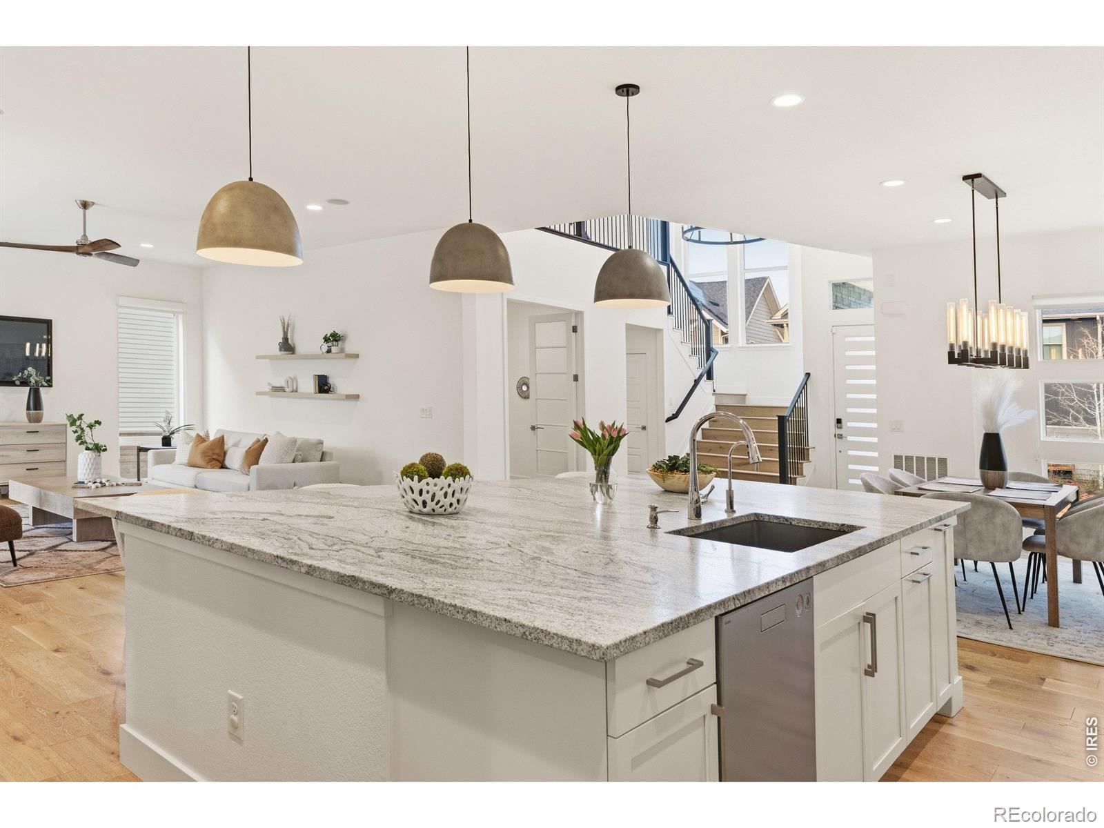 FINALLY, a home that checks the boxes buyers rarely find in one place-generous living spaces, modern finishes, and a location that puts parks, shopping, dining, and commuter routes just minutes away. From the moment you walk through the door, you'll understand why this home stands apart from the competition. Built in 2017, this contemporary residence impresses from the moment you step inside with soaring ceilings, wide plank engineered oak hardwoods, and dramatic floor-to-ceiling windows that flood the open main level with natural light. The seamless flow from the dining area into the show-stopping kitchen creates the perfect setting for both everyday living and entertaining-featuring white shaker cabinetry, an oversized statement island with designer pendants, gas range, double ovens, and an XL walk-in pantry. A thoughtfully designed mudroom adds everyday functionality. The bright, airy living room invites you to slide open oversized doors and extend your living space outdoors to a covered patio complete with a stacked stone gas fireplace-perfect for year-round gatherings.The low-maintenance yard, shaded by a mature tree, offers a peaceful retreat. Upstairs, you'll find four generously sized bedrooms including a luxurious primary suite with large windows, a walk-in closet, and a spa-inspired 5-piece bath with soaking tub, oversized shower, and dual vanities. The upper level also features a versatile layout with a secondary ensuite bedroom, two additional bedrooms with a shared bath, and a well-appointed laundry room with built-in cabinetry and utility sink. The newly finished basement expands your living options with a spacious rec room ideal for a home gym, media space, or playroom, along with a private guest suite and full bath. Don't forget to check out the community amenities: Enjoy parks, trails, and several community pools steps away.