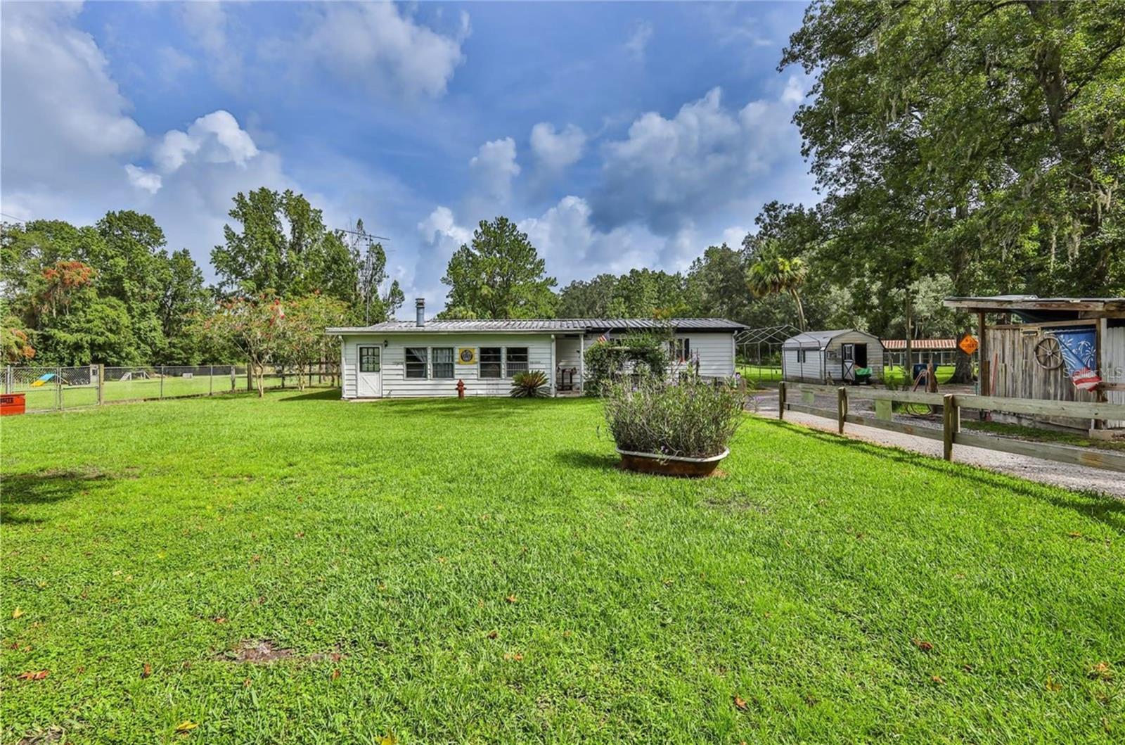 Endless possibilities and unmatched potential await on this extraordinary 28.40-acre property, ideally located just 1.4 miles north of historic downtown Brooksville on highly visible US Highway 98 North. Consisting of five separate parcels with expansive road frontage and direct access to major routes, including the Cobb Road Bypass and Cortez Boulevard, this property offers the perfect blend of convenience, privacy, and opportunity. Whether you envision a private country estate surrounded by majestic trees and winding walking trails, a thriving home-based business with space to grow, or a future commercial or industrial development, this versatile property can bring any vision to life. Currently zoned Agricultural, the land features a mobile home being used as an office and storage space, a large concrete block kennel building, three dog holding pens, a spacious open field ideal for training, events, or future expansion, and multiple wooded areas providing natural serenity and seclusion. The property is fully equipped with a private well and septic system, a lockable gated entrance, stabilized asphalt parking areas, and chain-link fencing around the active kennel site. With its strategic location, established infrastructure, and rare flexibility for residential, commercial, or developmental use, this property is a blank canvas for dreamers, entrepreneurs, investors, and developers alike. Create your dream homestead, launch your business, or build a multi-use destination in one of the most promising growth corridors of Hernando County — the possibilities here are truly endless.