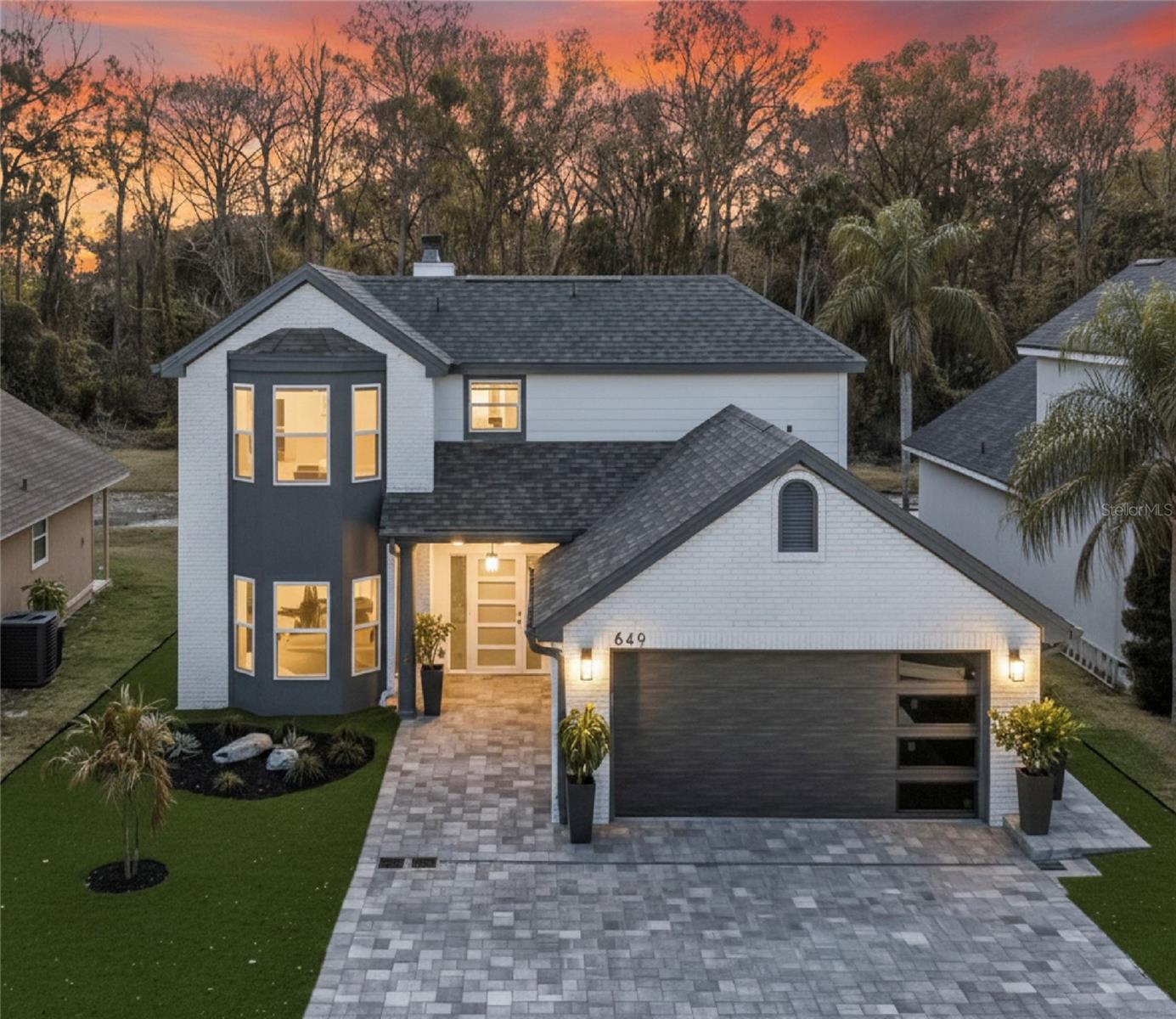 One or more photo(s) has been virtually staged. Stunning Lake Mary home! This beautiful 4 bedroom and 3 bathroom residence has been completely reimagined from top to bottom showcasing refined craftsmanship and sophisticated modern design throughout. From the moment you arrive, the custom European front door sets the tone for the exceptional quality found inside! Step into a light-filled interior highlighted by soaring vaulted ceilings, expansive living spaces and luxury vinyl flooring flowing seamlessly throughout the home. The designer kitchen features elegant quartz countertops, sleek soft-close modern cabinetry and brand-new stainless steel appliances—perfectly blending beauty and functionality for everyday living and entertaining. No detail has been overlooked with major recent upgrades including a NEW ROOF, NEW HVAC system, and NEW DOUBLE-PANE WINDOWS offering both comfort and peace of mind. The inviting family room is anchored by a charming wood-burning fireplace creating a warm gathering space while the modern architectural stair railing adds a striking contemporary touch. Enjoy outdoor Florida living with your own private retreat with a pavered terrace, built-in fire pit and adjacent grilling area all overlooking serene water and wooded views with NO REAR NEIGHBORS providing exceptional privacy and tranquility.This home is zoned for top-rated Seminole County schools and within walking distance to the public library, Greenwood Lakes Middle school and Lake Mary High School. Conveniently located just minutes from I-4, downtown Lake Mary, premier shopping, dining, and entertainment—this exceptional home offers the perfect blend of comfort and convenience.