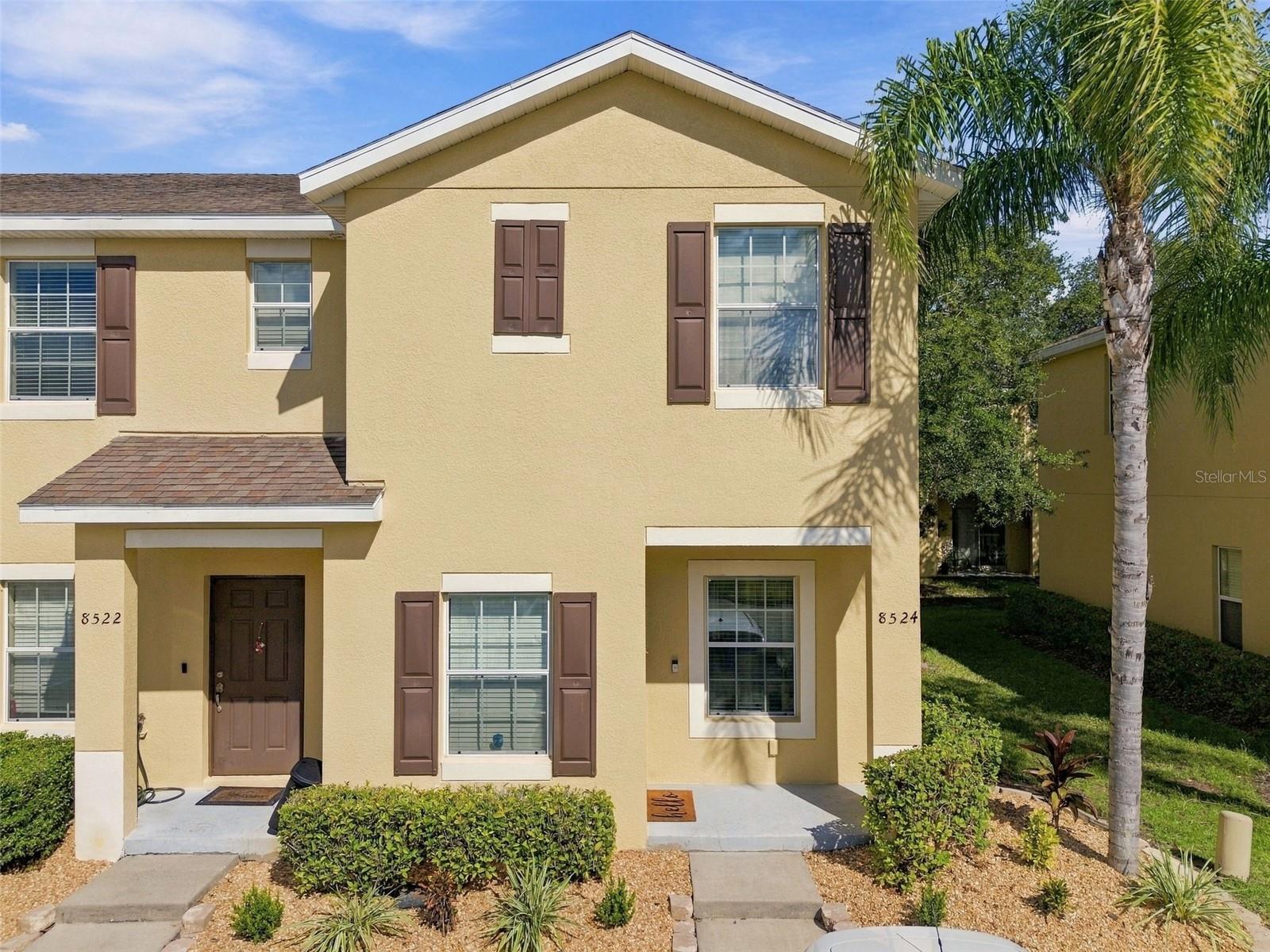Enjoy easy MAINTENANCE FREE living in this MOVE-IN READY END UNIT townhome in the gated community of Oakwood Village! With nearly 1,200 square feet, two bedrooms, and two and a half bathrooms, this home offers a functional layout with comfortable gathering spaces and a private bathroom for each bedroom. The kitchen features granite countertops, stainless steel appliances, a large pantry, and a breakfast bar that connects to the open living and dining area. Nine-foot ceilings and plenty of windows give the entire home an airy feel, while a conveniently located half bath serves guests. Upstairs, both bedrooms feature EN-SUITE BATHROOMS with granite countertops. Ceramic tile throughout the main floor and bathrooms pairs with engineered hardwood upstairs for a home with no carpet. Exterior upkeep is simplified with HOA coverage that includes landscaping, the building exterior, roof, internet and security gate. There are 2 assigned parking spaces located near the front door with plenty of guest parking available. Residents also enjoy access to two pools, a fitness center, picnic area, green spaces, and a nature trail, offering plenty of ways to unwind close to home. Located just south of County Line Road, this home puts I-75, Tampa Premium Outlets, The Shops at Wiregrass, USF, shopping, and dining within easy reach. A welcoming end-unit setting, thoughtful layout, and community amenities make this Oakwood Village townhome a wonderful place to call home!
