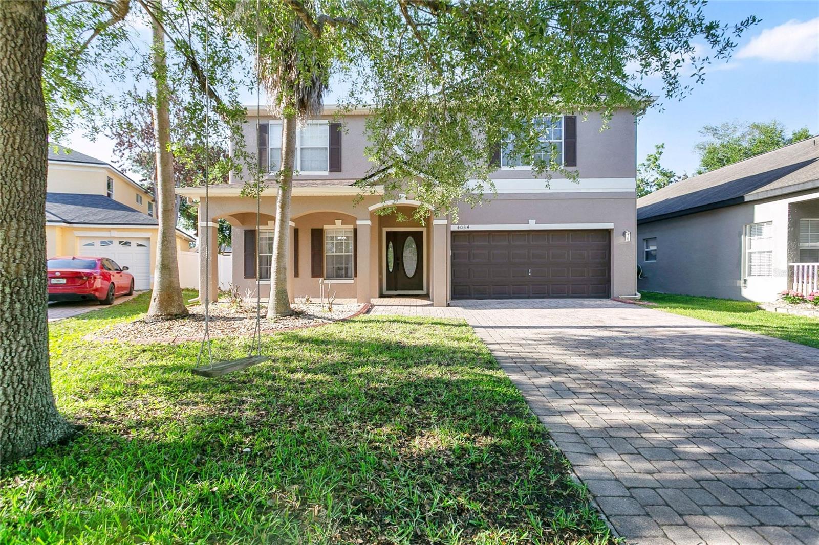 Gorgeous two-story home where elegance and comfort come together seamlessly. Featuring marble floors, granite kitchen countertops, and beautifully updated cabinetry, this residence offers spacious living throughout, including large rooms, formal living and family areas, and a covered patio overlooking a generous backyard. This stunning five-bedroom, three and half-bathroom home welcomes you with a paver driveway, two-car garage, covered front porch, and lush landscaping accented by palm trees. Inside, you’ll find elegant formal spaces highlighted by chandeliers and gleaming tile floors. The well-appointed kitchen serves as the heart of the home, complete with stainless steel appliances, pantry storage, bar-top seating, granite counters, and abundant cabinet space, all enhanced by rustic light fixtures. A bright breakfast nook offers backyard views, perfect for casual dining. The open family room features soaring ceilings, a convenient half bath, and sliding glass doors leading to a screened patio with vaulted ceilings. Upstairs, the spacious primary suite includes a large walk-in closet, dual vanities, a soaking tub, and a glass-enclosed shower.  The additional guest bedrooms are also located upstairs for added comfort and privacy. Enjoy outdoor living with a large fenced backyard and covered patio—ideal for relaxing or entertaining. Conveniently located near parks, schools, shopping, dining, and major highways, this truly fantastic home offers the perfect blend of style, space, and location. Schedule your private showing today!