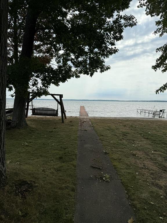 Don't wait to see this charming 3-bedroom, 2-bath lakefront home on beautiful Houghton Lake! Enjoy your own private dock for fishing, boating, kayaking, or simply relaxing as you take in breathtaking sunsets over the water. Step out through the sliding door with built-in blinds onto your spacious deck -- the perfect place to entertain, unwind, and soak up the lake views. This well-maintained home features a new metal roof (2024), new furnace, and new tankless water heater for comfort and efficiency. Inside, you'll love the new vinyl flooring and the convenience of all appliances included, even a new refrigerator. The property also offers a large 2-car detached garage for storage or lake gear. Additional highlights include central air and Houghton Lake Schools. Whether you're seeking a full-time residence or a second vacation getaway, this move-in ready lakeside retreat is waiting for you to start making lasting memories today!