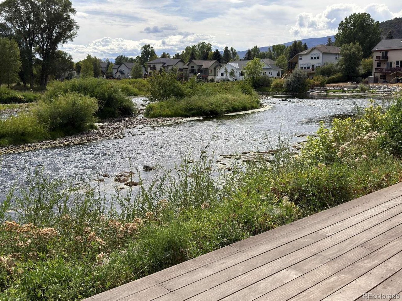 Rare Eagle Riverfront Oasis in Gypsum -- Fish From Your Deck! Welcome to a premier 3-bed, 2-bath riverfront home in a quiet cul-de-sac. This property offers an unparalleled Colorado lifestyle, combining modern upgrades with a direct connection to the Eagle River. The highlight is a massive 500-sq-ft private deck spanning the back of the house. Because the property line uniquely extends into the river, you can fly fish right off your own deck. Whether catching trout at sunrise or relaxing to the sounds of the water, this outdoor space is a true sanctuary. Inside, the home balances sophisticated finishes with high-efficiency comfort. PREMIUM FINISHES: beautiful hardwood floors flow through the main spaces, complementing stunning quartz countertops in the kitchen. COZY WARMTH: stay warm all winter with premium in-floor radiant heat. EXTERIOR UPGRADES: features brand-new, low-maintenance LP Smart side siding for excellent durability and peace of mind. Enjoy a peaceful neighborhood with no through traffic and a backyard that feels like a wilderness retreat, all while staying minutes from local amenities. Properties with actual riverbed ownership are incredibly rare -- don't miss your chance to own a piece of the river.