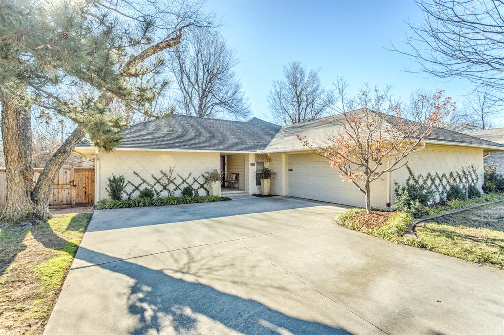 Prepare to be CHARMED! This beautifully maintained 3-bedroom, 2-bath ranch-style home blends timeless comfort with charming cottage appeal. This home sits right between Nichols Hills and The Village. From the moment you step inside, you’ll notice the lifted ceilings in the living area, creating an open, airy feel complemented by large windows and abundant natural light. Wood shutters and wood flooring add warmth and character throughout.The spacious primary suite offers a cozy retreat, complete with a large soaker tub and the ever-popular “The Party” toile in the master bathroom. A dedicated wet bar makes entertaining effortless, while the thoughtfully designed kitchen features quartz countertops, a lazy Susan, retractable shelving, and a KitchenAid dishwasher for everyday convenience.This home has been exceptionally cared for and thoughtfully updated, including HVAC re-run to the ceiling for improved comfort. Practical upgrades include full gutters with leaf guards, front and back sprinkler systems, and capped cedar fencing in excellent condition. The garage floor houses an 8-person storm shelter, providing peace of mind without sacrificing space.  The large, very private backyard is perfect for evenings on the patio. With its blend of character, functionality, and pride of ownership, this inviting home is as practical as it is charming.