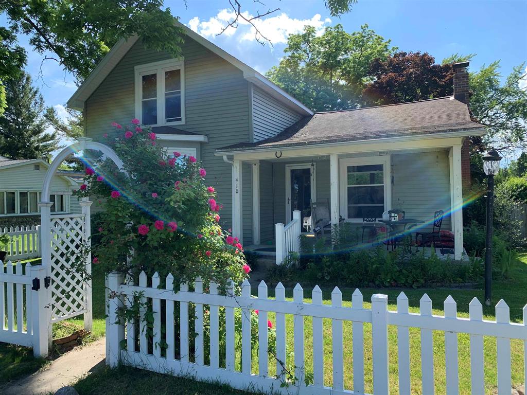 Conveniently located in Tawas City, this charming 2-bedroom, 1-bath home sits on an oversized 98.5 x 120 lot and offers city water and sewer, natural gas, and a detached garage. The kitchen provides ample storage, while the living room features beautiful hardwood floors and a bay window that fills the space with natural light. The full bathroom was updated in 2018 and includes a Homeward Bath jetted tub for added comfort. Additional updates include a new boiler installed in 2020, connected to the hot water heater to ensure a continuous supply of hot water, as well as insulated vinyl siding added in 2018. The main level includes two bedrooms, while the upper level offers a third bedroom along with a cozy sitting area. Previously used as an apartment, the upstairs presents great potential with a little creativity and vision. The 16 x 22 detached garage features a cement floor and single-car access. Outside, the fenced-in yard provides privacy and is perfect for pets. Enjoy outdoor living with a welcoming front covered porch and a backyard deck-perfect for relaxing or entertaining-set among abundant perennial landscaping that can be enjoyed throughout the seasons. Ideally situated near the sandy beaches of Lake Huron and a nearby canoe/kayak launch, this home offers easy access to the natural beauty of the ‚Å“Sunrise Side.‚  Enjoy local forestry, hiking, and biking trails, Corsair ski trails, Tawas State Park, and all the amenities of Tawas City and East Tawas. Whether you're searching for a year-round residence, a retirement retreat, or the perfect northern Michigan getaway, this property is full of opportunity. Schedule your showing today!