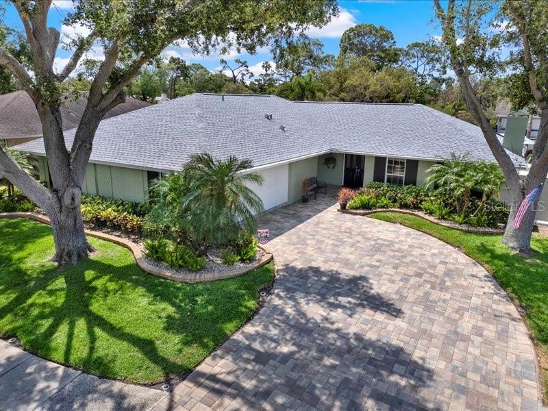 Immaculately cared for Executive 4 bedroom, 3 bath, POOL HOME.  The total care to detail by this owner shows and you will be impressed.  It shows in every way.  Located in the much desired neighborhood of Linden Place.  This home offers 4 bedrooms, 3 baths, Two living rooms, a fireplace, Dining room, lots of closet space, an inside laundry room, a 2 car garage, etc.  The kitchen has great cabinet space with solid wood cabinets, an island, plenty of counter space, and lots of windows.  All of the appliances have been replaced. There are two sets of French doors in the living area that lead out to the large covered lanai and the renovated salt water pool which is absolutely beautiful with Travertine pavers surrounding the pool and continuing throughout the Lanai and the side of the home.   Another set of French Doors leads out to the Lanai from the Dining Room.  The primary bedroom has two walk-in closets,  an en suite bathroom with double sinks and the bedroom has French doors leading out to the Lanai. There is also a Solar Pool Heating System.  Newer Roof replaced 2017.  New 5 ton Air Conditioner 2024.  Water heater replaced in 2022.  PGT Windgard windows and a hurricane rated garage door, along with Hurricane shutters that surround the entire back Lanai.  The driveway has been expanded three extra feet and had beautiful pavers added.   Commercial grade PVS Fence surrounds the gorgeous yard with 2 gates. The landscaping is beautifully done and well cared for.  There is also an automatic irrigation system with a well.   This is a great home for entertaining.  Lots of space inside of the home and the outside living area. This home can come partially furnished or seller can remove the furnishings.  Great location and only minutes to the beautiful beaches.    This home has so much to offer.  You need to come and see for yourself!