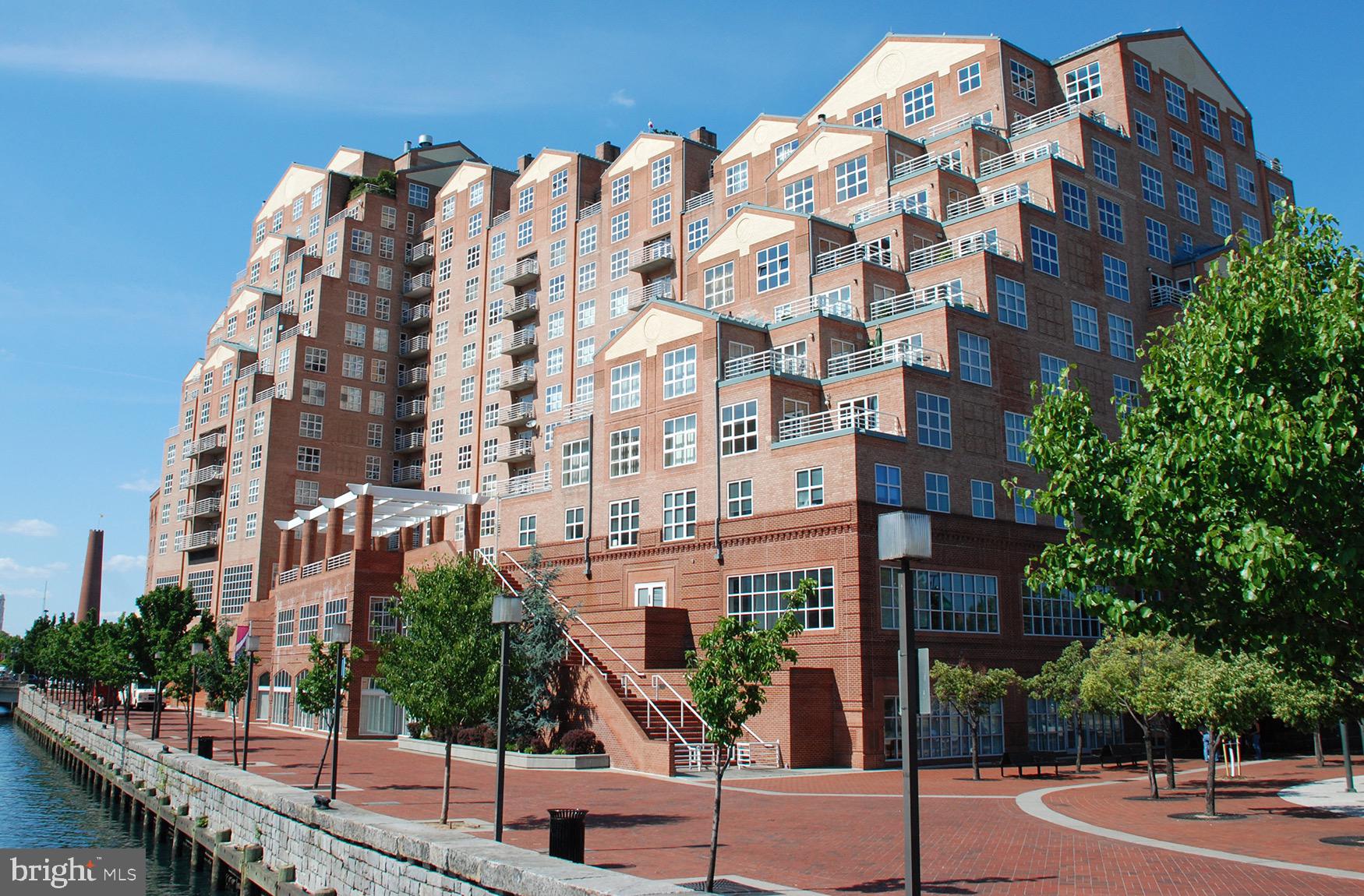 Updated 2-bedroom, 2-bath condominium with a den at Scarlett Place. Offering nearly 2,000 square feet, this is one of the largest 2-bedroom floor plans in the building. The unit features remodeled flooring, an updated kitchen, a private balcony with expansive water and city views, and one deeded parking space. The property is currently tenant-occupied through February, providing immediate rental income for an investor.Building amenities include a 24/7 front desk, indoor pool, fitness center, library, billiards room, and community room. This well-maintained unit combines generous living space with the convenience and amenities of a full-service building.