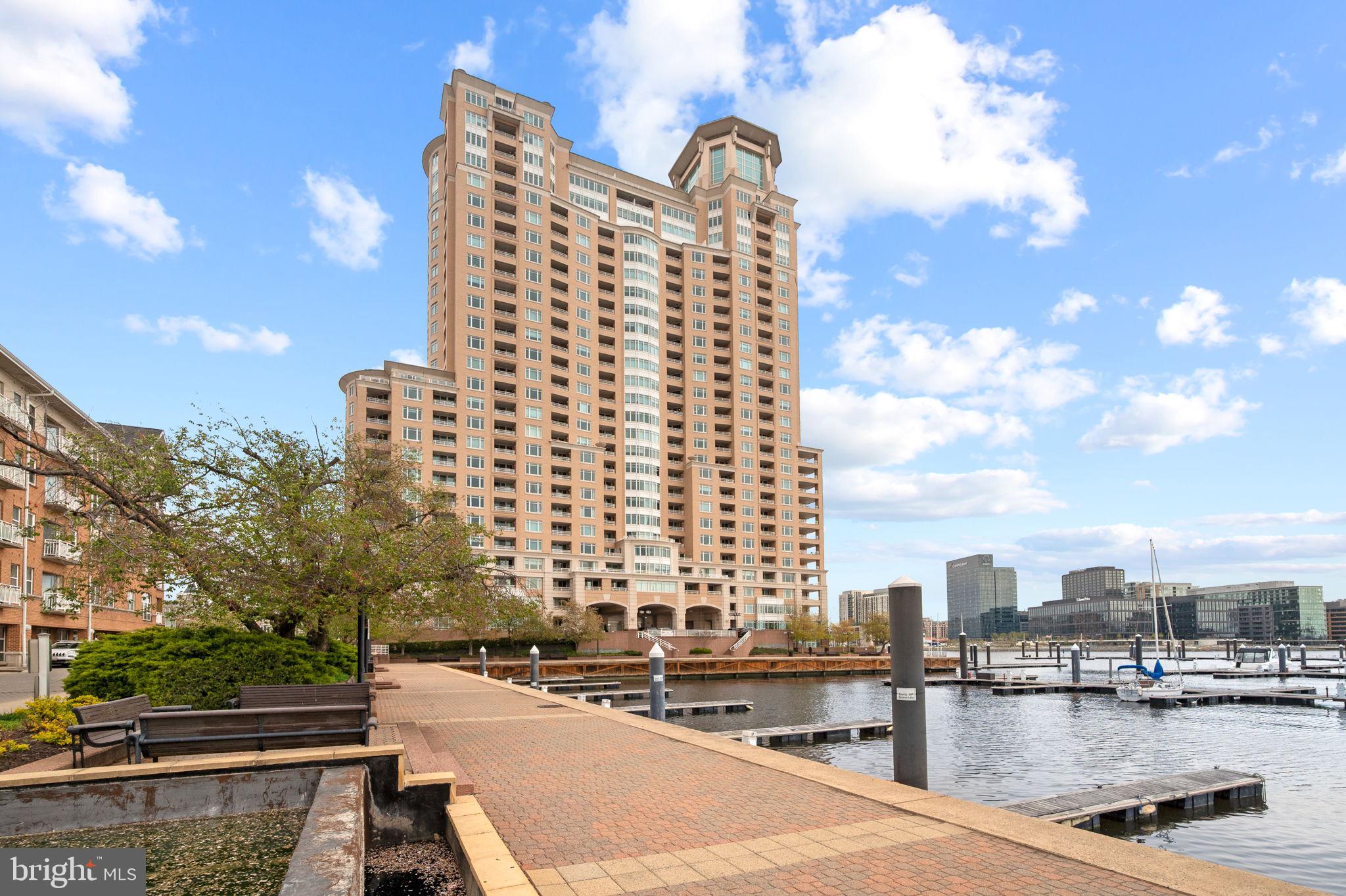 HarborView Marina & Yacht Club – The Place to be Impressed! Experience the pinnacle of urban waterfront living in this 3BR 2BA luxury condo. From the moment you pass through the elegant French double-door entry of this magnificent home, your eyes are immediately drawn to the dramatic, panoramic vistas framing the bustling Inner Harbor waterways and the vibrant city skyline! Boasting 1,772 square feet of bespoke designer luxury, this residence seamlessly blends high-end craftsmanship with the comfort of home. This is truly where architectural elegance meets breathtaking natural beauty with unparalleled custom features and design, meticulously crafted for comfort and elegance. Throughout this home you’ll find Mannington Adura Max luxury vinyl flooring, stylish accents of Blue Quartzite kitchen countertops, backsplash and window sills, 6” ultra-thin LED recessed ceiling lighting, custom closet systems, some with Lutron motion sensor switches, newly updated electrical switches and outlets, , type A and C USB charger outlets and power sources at windows and exterior doors for electronic shade capabilities.Living Room features include a 50” Smart WiFi infrared electric fireplace with sound crackling and realistic flame. The Chef’s kitchen is equipped with all the bells and whistles to include cabinets with pull-out base drawers, end and front panels and crown molding, Kraus Kore 16-guage stainless steel workstation sink with integrated ledge and accessories, Delta Keele single-handle pull down sprayer, LED under cabinet lighting, KitchenAid stainless steel appliances and an InSinkErator instant hot water dispenser.  Each bedroom is uniquely outfitted with custom walk-in closets! Baths offer LED vanity lights and mirrors with anti-fog, dimmable, back and front lit, charger outlets, undermount sinks and premium upgraded faucets and fixtures.  This Flexible Luxury floorplan features two spacious balconies, both offering an unparalleled indoor-outdoor lifestyle all year round!  Enjoy Five-Star Building Amenities & Services! Living at Harborview Towers means enjoying an effortless, resort-style lifestyle backed by top-tier security and convenience with 24/7 front desk concierge, garage valet, secure bike storage, and ample guest parking.  Wellness & Leisure features include Indoor and outdoor swimming pools, an extensive fitness center with relaxing steam and sauna room. For your entertainment and business requirements, enjoy sophisticated social lounges, billiard room, private dining rooms, and a work room with computers and printer. Plus, dedicated guest suites for your visitors!  The HarborView Marina and Yacht Club Grounds are Beautifully landscaped featuring walking/jogging paths, serene fountains, an on-site marina, and a premier gourmet deli right at your doorstep!  The community offers an Unbeatable Location perfectly positioned for both lifestyle and commute. Enjoy seamless access to I95, DC, 695, the downtown business district, stadiums, high-end shopping, and world-class nightlife. Traveling is effortless with the nearby MARC train and BWI International Airport just a short drive away. A MUST SEE so schedule your tour today!
