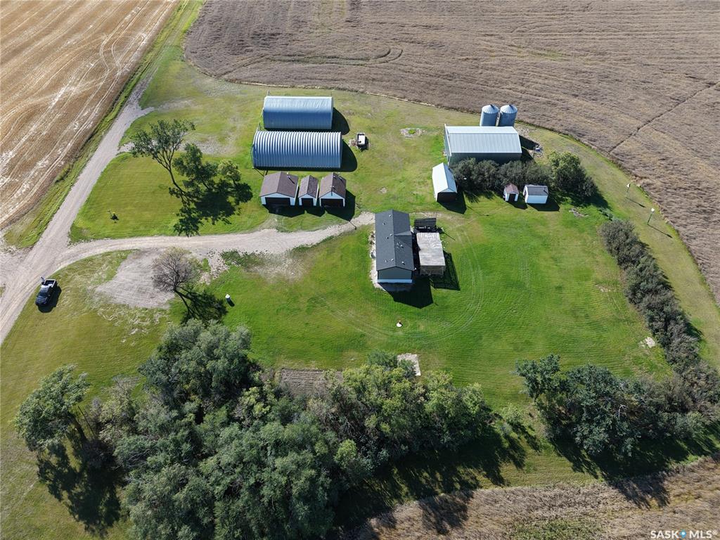 Rare opportunity to own 10 acres less than 15 minutes NW of Saskatoon just east of Bergheim Estates with limited neighbors.  This very private parcel is located at the end of the road with only has one part time neighbor is waiting for someone to build their dream acreage home on it!  It is a very quiet serene setting with great views in all directions.  The property is completely serviced including natural gas with a meter in place, power connected and being used, municipal water on a drip system with the tanks and pressure system housed in one of the heated out buildings, a generac natural gas back up generator and a septic system with liquid surface discharge.  In addition to saving utility service costs there are numerous valuable buildings on site that all have power to them.  The possibilities are endless with opportunity for vast storage or converting some of the buildings to heated work shops.  The outbuildings include a 40x56x16 foot conventionally framed building on a concrete footing that could easily be insulated, heated and have a concrete floor poured to use as a dream shop,  a 40x60 wooden arch framed building on a concrete footing, another good candidate for a heated shop and a 46x70 steel archrib quonset great for cold storage of boats, RV's ect.  In addition there is a 24 x24 detached garage with concrete floor and electric garage door opener that is heated with an oil furnace and a 18x24 heated garage that is home to the pressure system and also set up as a small workshop.  There are numerous other buildings in good shape, usable and fully powered.