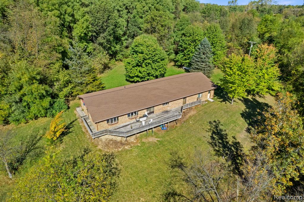 Sprawled across 11 private acres with direct lake access and 330 feet of lake frontage, this expansive 4,900 sq ft home offers the rare opportunity to create your dream retreat from the ground up. Whether you're envisioning a luxurious modern escape, a rustic lodge, or a multi-generational family compound, this blank canvas is ready for your vision.The structure allows a generous square footage, flexible layout potential, and solid bones, providing the perfect foundation for renovation. With serene lake views, wooded privacy, and ample space for additional structures, gardens, or recreational amenities, the possibilities are truly endless.Enjoy the tranquility of nature with room to roam, yet still be conveniently located within reach of local amenities. Properties of this size, location, and potential are a rare find—bring your plans and make it yours.