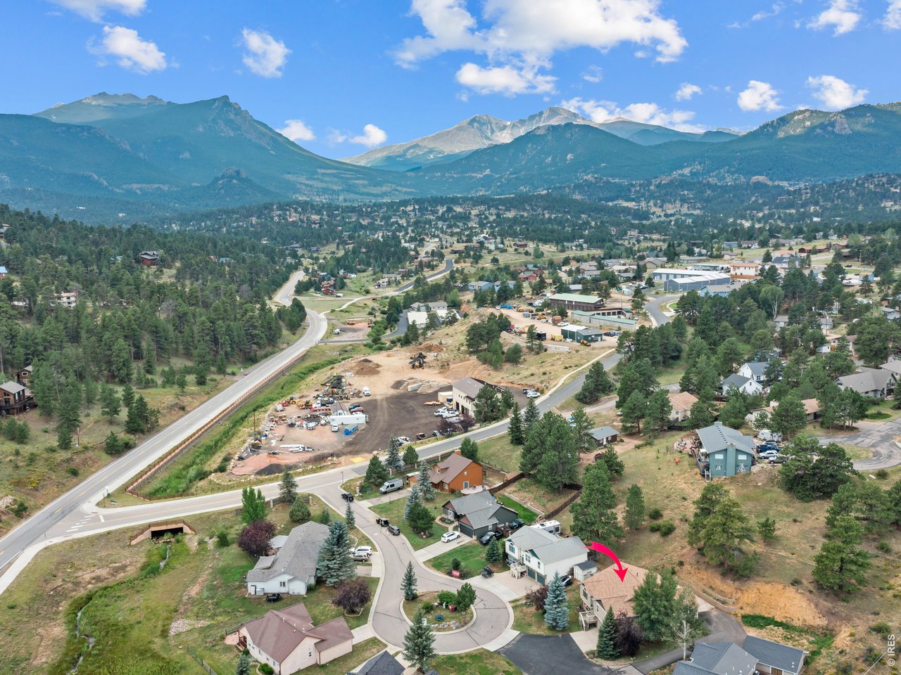 Discover the perfect blend of space, flexibility, and mountain living in this beautifully maintained 5-bedroom, 4-bath split-level home on a generous 0.34-acre lot in a quiet cul-de-sac. Ideally located just minutes from shopping, dining, medical facilities, and recreation, you'll enjoy convenient access to everything Estes Park has to offer while being tucked away from the busiest tourist areas. Designed with versatility in mind, the home features two spacious primary suites plus two additional bedrooms. The lower level includes a large flex room with its own bathroom and closet, making it ideal as a fifth bedroom, family room, game room, home office, or guest suite. The thoughtful floor plan offers multiple living spaces, including a separate living room that can also serve as a formal dining room. The open great room combines the kitchen, dining, and family room, creating an inviting space for everyday living and entertaining. The kitchen features stainless steel appliances, and the laundry room includes a washer, dryer, and built-in commercial dryer. Enjoy being less than five minutes from the golf course and under ten minutes from downtown Estes Park and Safeway. The Fish Creek Trail, just steps from the home, provides easy access to Lake Estes and miles of scenic walking and biking trails. Relax on the peaceful flagstone patio while taking in panoramic views of Longs Peak, Twin Sisters, and Kruger Rock. Frequent wildlife sightings complete the mountain lifestyle. A shared driveway along the right side of the home provides convenient access to the backyard and back entrance, offering excellent accessibility. Home is digitally staged.