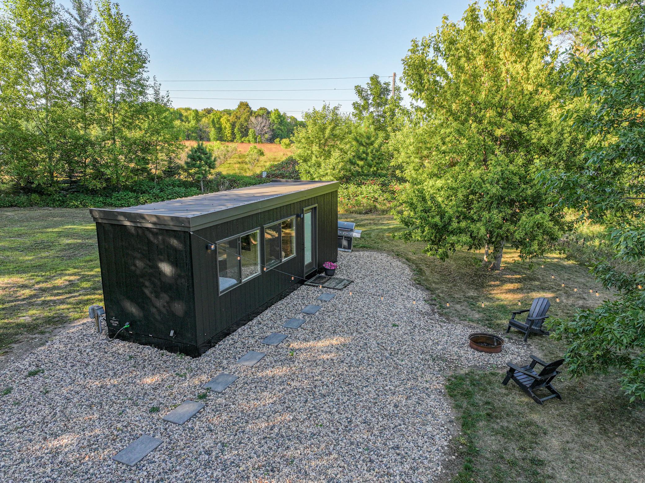 Some big things come in small packages. This Tiny Home boasts of a trendy vibe, country retreat for relaxation or future homesteading. This piece of heaven is seated on just under 3 acres, adorned with mature oak trees, overlooking a natural landscape. Bask across the fields of green and gold and see nothing but nature. Enjoy the peace and quiet to the country, but have the amenities of a tar road, close to Gove Lake that has a public beach and park and the iconic "Padua Pub". If you are looking to invest in a VRBO/Air B & B, create a homestead, or use it the way it sets, this just might be the place for you. It comes with a 2025 e-Vista XL, Escape Traveler that is the coolest thing ever. Whether you are into "Glamping", Homesteading, or investing, this little gem just might be right for you. It comes with a well, 3-50 amp camper hook ups, a compliant septic, power run in, and driveway installed, and landscaping, so come as you are, come as you may, and let your cares drift away, as you cozy into this crafted place called "Oak Crest."
