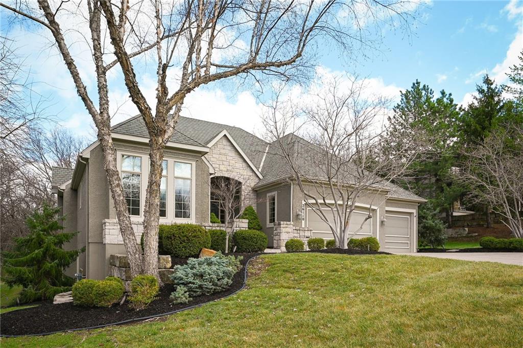 Set at the end of a quiet cul-de-sac in Cedar Creek, this meticulously maintained reverse 1.5-story pairs refined scale with a private, tree-lined backdrop. With 4 bedrooms, 3.1 baths, a 3-car garage, and 4,015 square feet on a .42-acre lot, the layout delivers substantial main-level living with beautifully finished space below.Approximately 2,815 square feet on the main floor is elevated by high ceilings, generous windows, and seamless flow through the formal dining room, great room, hearth area, and kitchen. A see-through fireplace connects the great room and hearth room, creating warmth and architectural interest. Designed for both daily living and entertaining, the kitchen features a Sub-Zero refrigerator, Viking cooktop, wine fridge, bar-height seating, and breakfast nook.The main-level primary suite offers a calm, spacious retreat with vaulted ceilings, soft natural light, and peaceful views of the trees beyond. The ensuite bath is designed for everyday comfort with a jetted tub, double vanity, and a walk-in shower with an open entry. A substantial walk-in closet adds exceptional storage and organization, completing a private haven that feels both luxurious and serene.Downstairs, the finished daylight walkout lower level adds exceptional flexibility with a large family room, fourth bedroom, full bath, and abundant unfinished storage. Outdoor living continues with a screened porch featuring composite decking, a patio, in-ground sprinkler system, and a setting that backs to mature trees.Located in one of west Olathe’s most desirable communities and served by Olathe schools, Cedar Creek offers swim and racquet amenities, pickleball and tennis courts, Shadow Lake, trails, neighborhood events, and more. Golf is available with separate membership, while convenient access to 119th Street, K-10, and the greater Kansas City metro adds to the appeal.Arrange your private tour to appreciate the setting, layout, and finish in person.