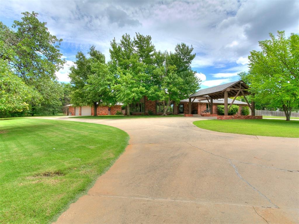 ** 2 SWIMMING POOLS ** HOT TUB ** 1.37 ACRE LOT ** POSSIBLE 6 BEDROOMS ** EDMOND SCHOOLS!!! DIVING/SWIMMING POOL with new diving board and newly resurfaced - 10ft deep and great for jumping, diving and lap swimming. SECOND POOL is a SPORT POOL with slide - perfect for volleyball, basketball, Marco-polo and all your favorite pool games. The grounds are picturesque and relaxing with over 55 trees, multiple patio spaces, fire pit, Trex deck area, fenced dog run, garden areas and 24x12 outbuilding. PARKING AND MORE PARKING! - with the large driveway, circle drive, PORTICO, and extra parking near the garage - you can invite the "whole town" to your Pool Party, they can all drive separately, and still have parking to spare! Recent updates include: New quartz countertops, new tile backsplash, new coping on diving pool, new pool/spa heater 2024, New carpet at living and dining 2024, New septic system 2022 and much more - ask for full features list. Flexible floor plan - see floor plan in photos - study could be bedroom 5, and theater room could be bedroom 6. Large living room with vaulted ceiling. Formal dining could also be used as a den or pool table room. Sun room adds even ADDITIONAL living room. Come see this one today!