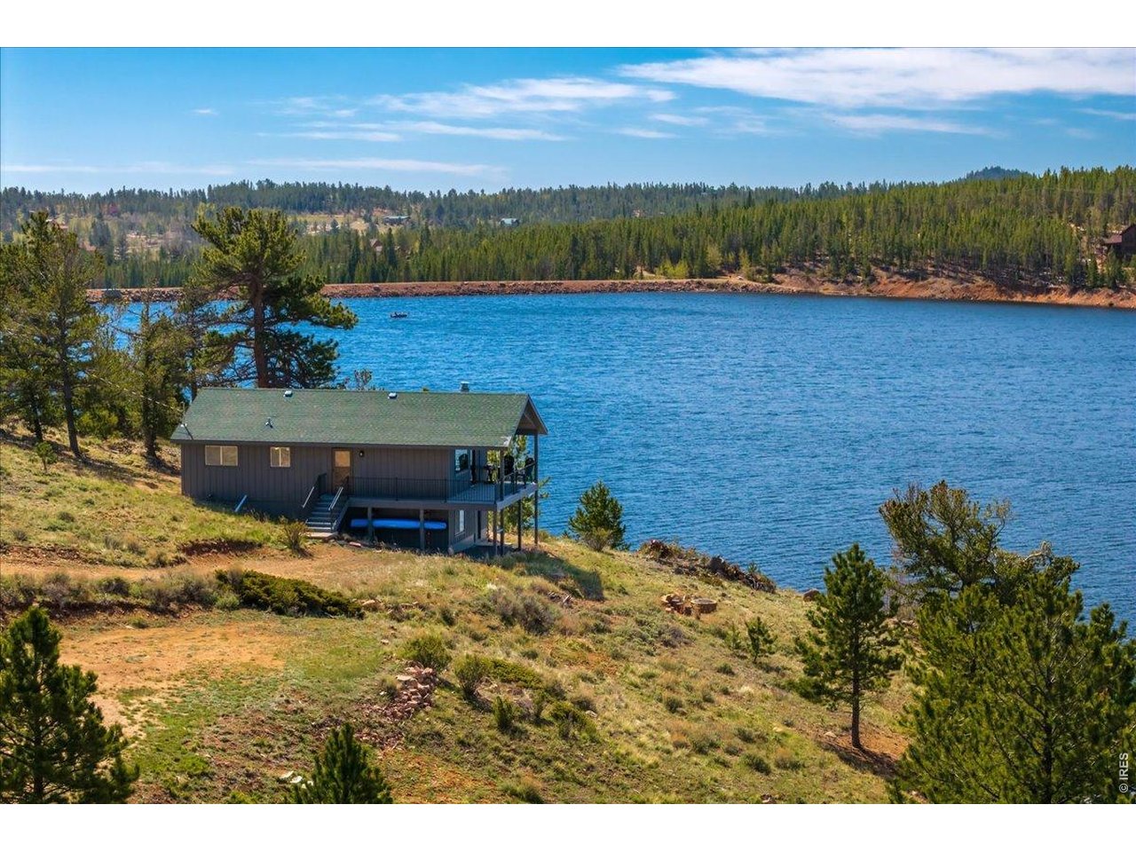 LAKEFRONT home!! Experience the serenity of mountain living in this delightful 2-bedroom, 1-bath home set along the tranquil shores of Crystal Lake in Northern Colorado. This inviting property is perfectly suited for year-round enjoyment, offering modern comforts such as a private well and a vault, ensuring both convenience and self-sufficiency no matter the season. Step outside onto more than 300 square feet of deck space, where you can take in sweeping lakefront views, breathe in the fresh mountain air, and watch wildlife meander through the natural landscape. The recently updated decking and fresh exterior paint add to the home's charm and make outdoor relaxation effortless-your biggest concern will simply be deciding when to cast your fishing line. Inside, you'll find a thoughtfully designed layout with bedrooms, bath, living room, and kitchen all conveniently located upstairs, providing easy access and natural light. The spacious family and recreation room in the basement offers a versatile area perfect for gatherings, games, or cozy evenings. Whether you're seeking a peaceful retreat, a place to entertain loved ones, or a home base for outdoor adventures, this lakefront gem has it all.
