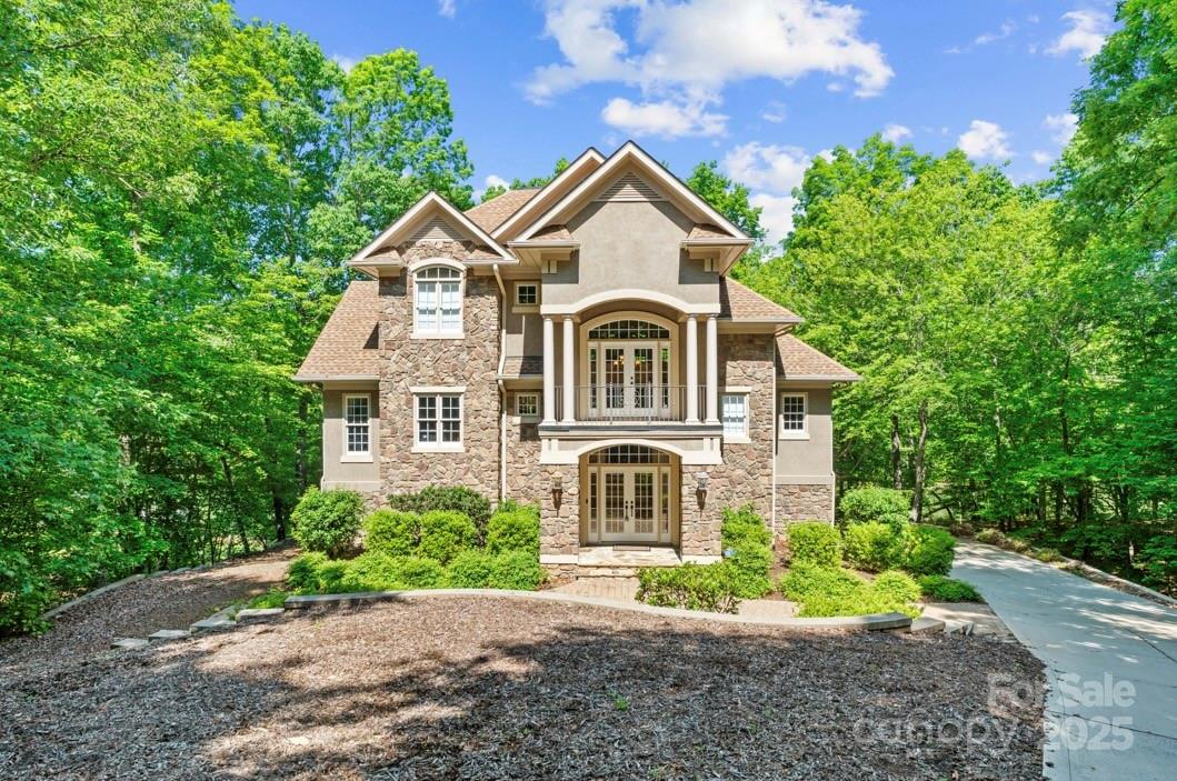 This beautiful custom build lakefront home w/private pier, floating dock & covered boat lift is waiting on its new owner! Bring your paddle boards, fishing pole, boat or just relax on the dock. Located in a cove in the lovely Heron Bay community-amenities include walking trails, clubhouse, pickleball court, boat ramp and boat storage if needed. This gorgeous home has 3 bd 3 bth, granite countertops, floor to ceiling windows in living area, stone gas log fireplace, remote control shades, oak flooring, tile showers, screened patio, front balcony, private balcony/primary bd, large veranda style balcony overlooking the pier, outdoor shower, basement with entertainment room (could be used as a guest suite), roof 2024, oversized 2 car garage...this lakefront beauty has so much to offer!! ALL furnishings, appliances, TVs, pool table, hot tub and kayaks will convey with accepted offer. *Pier/dock water depth measured 16ft on 5-8-25 (Agents see remarks). Call today & schedule showing