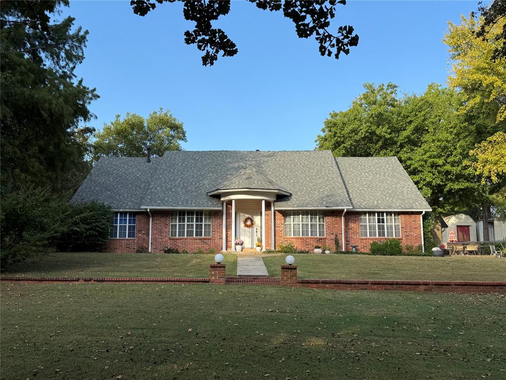 **OPEN HOUSE SUNDAY FROM 2:00-4:00** Set on five serene acres with mature trees—including two plus acres of natural woodland—this property blends privacy, space, and everyday convenience within the Carl Albert School District. The home features two living areas, a large dining room, an enclosed patio room, and a cozy fireplace. The kitchen offers a breakfast bar and a full walk-in pantry. The primary bedroom is extra spacious and large enough for a sitting area as well. The walk in closet has built ins for additional organization. The primary bathroom was recently upgraded with a walk in shower and built in seat. The home includes two full and one half baths in total and four very comfortable sized bedrooms. Storage capacity is built into every thinkable location. 
Outdoor living shines here and includes multiple patio areas, a firepit area, a flagpole, and a picturesque driveway to welcome gatherings large and small. Practical extras add major value—an oversized garage, a carport sized for RV parking, two workshop/sheds, and an outdoor storm shelter. Major system updates include a one-year-old roof, two HVAC units (one recently replaced), two hot water heaters, energy efficient windows replaced approximately six years ago, and a recent septic line update. A dedicated storage room keeps everything organized. This property will captivate your heart from the moment you turn into the driveway.
